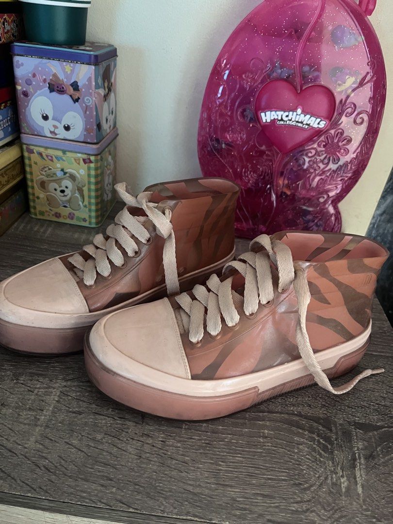 Melissa Pink Jelly Sneakers (Category: Sneakers) located in Cebu City. Submitted by abct1 (Listing ID 1422368440, Image 1). Description: - Melissa jelly sneakers - High-top design - Transparent upper - Solid pink sole - White laces - Brand name visible - Size: US 9A / EUR 33/34.
