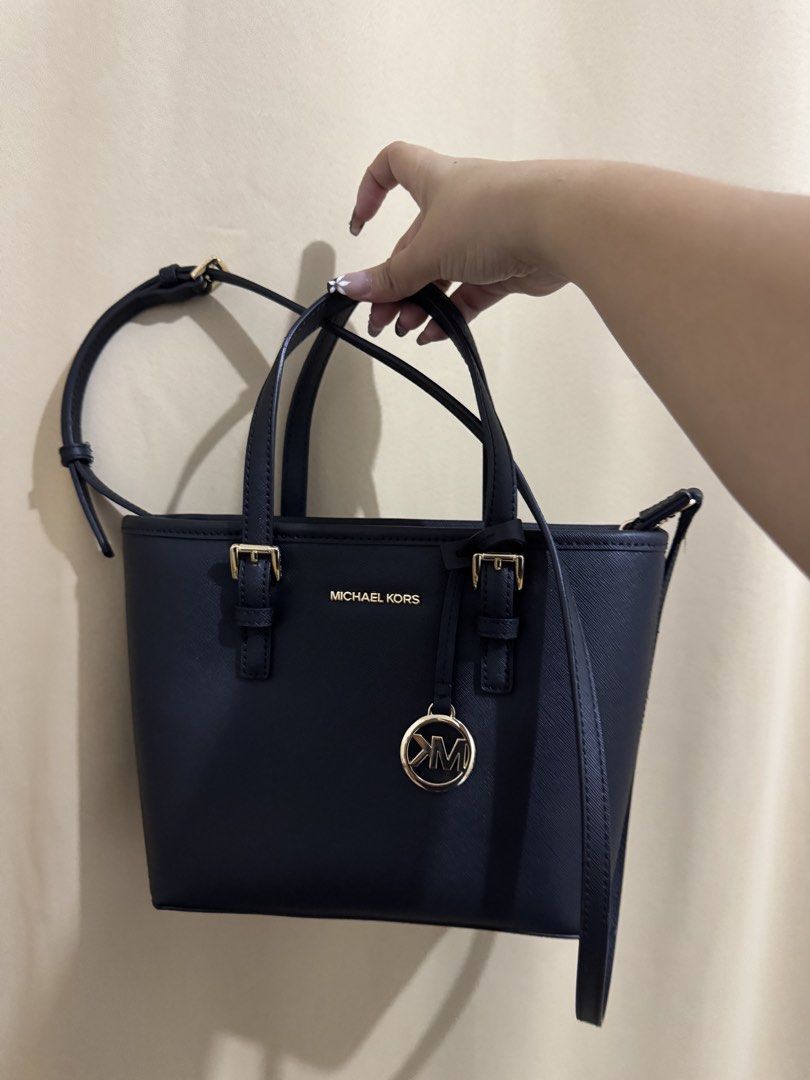 Michael Kors Black Tote Bag (Category: Luxury Bags & Wallets) located in Cavite. Submitted by mchrstl (Listing ID 1422387848, Image 1). Description: Selling my Original MK Jet Set Travel XS Saffiano Leather Top-Zip Tote Bag in Black with Gold-tone hardware Used once. Good as new No ISSUE lalamove cod sf only Meet up: SM DASMA/ROB PALA PALA/WALTERMART MANGGAHAN Loc: Gentri, cavite PASS SA BARAT. Not rush .