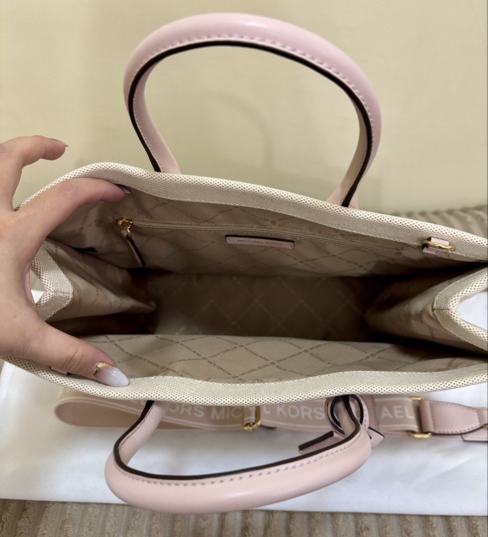 Michael Kors Mirella Canvas Tote Bag (Category: Luxury Bags & Wallets) located in Batangas. Submitted by jmmac (Listing ID 1422245860, Image 2). Description: - Michael Kors tote bag - Canvas exterior - Pink leather accents and handles - Detachable shoulder strap with Michael Kors logo - Lined interior - Zippered pocket - Detachable charm.