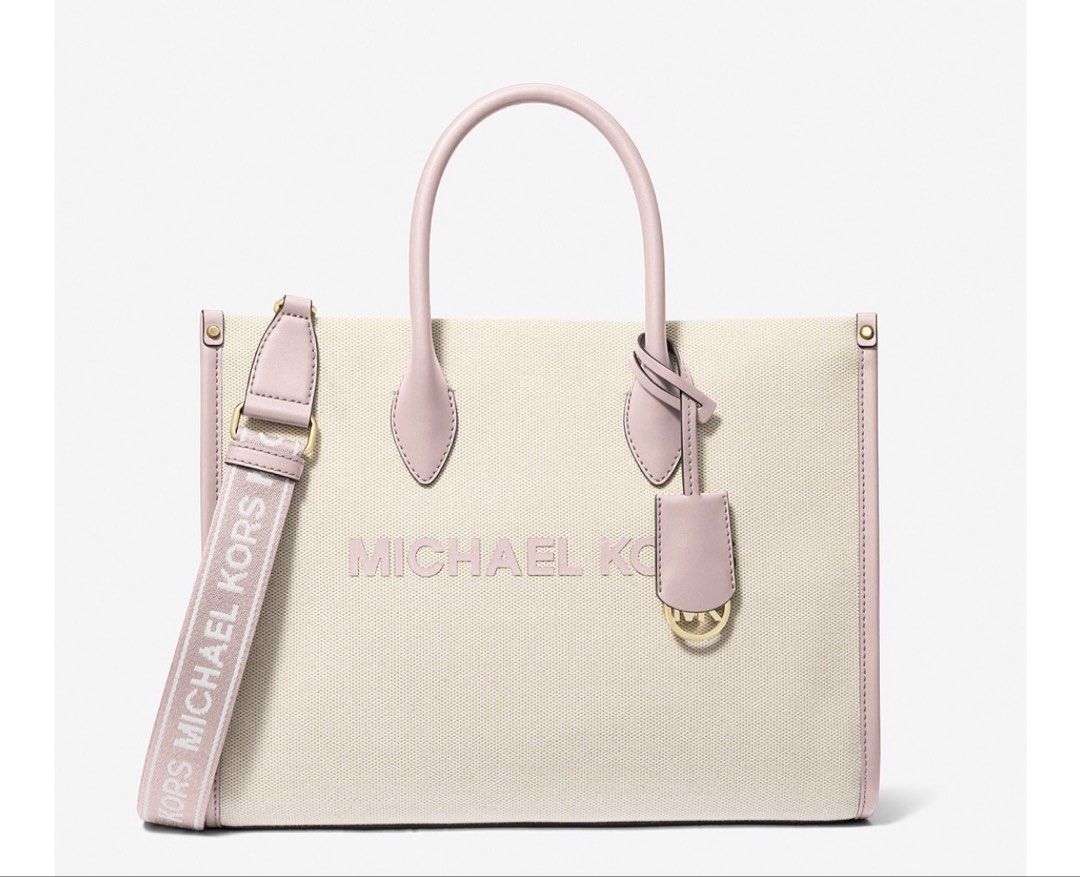 Michael Kors Mirella Canvas Tote Bag (Category: Luxury Bags & Wallets) located in Batangas. Submitted by jmmac (Listing ID 1422245860, Image 3). Description: - Michael Kors tote bag - Canvas exterior - Pink leather accents and handles - Detachable shoulder strap with Michael Kors logo - Lined interior - Zippered pocket - Detachable charm.