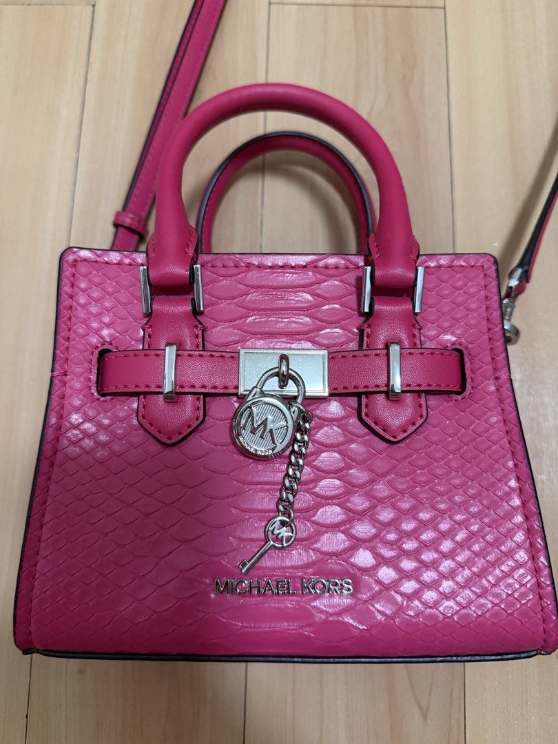 Michael Kors Pink Handbag (Category: Luxury Bags & Wallets) located in Manila. Submitted by ziaaa012 (Listing ID 1422352167, Image 2). Description: - Authentic Michael Kors handbag - Eye-catching pink color - Top handle and detachable shoulder strap - Textured exterior - Silver-tone lock with Michael Kors logo - Interior zippered compartment - Dimensions: Approximately 15cm x 18cm x 15cm.