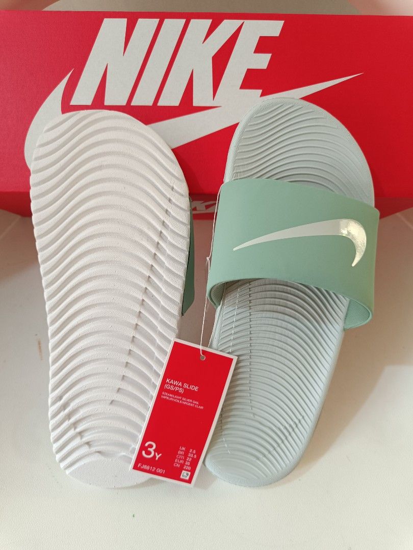 Nike Kawa Slide Sandals 3Y (Category: Babies & Kids Fashion) located in Cavite. Submitted by disyc (Listing ID 1422381819, Image 2). Description: Nike Kawa Slide sandals in mint green. Features the Nike swoosh logo on the strap. Includes the original box and tags. Size 3Y. The sandals have a textured footbed for comfort and grip. Perfect for everyday wear or after sports activities..