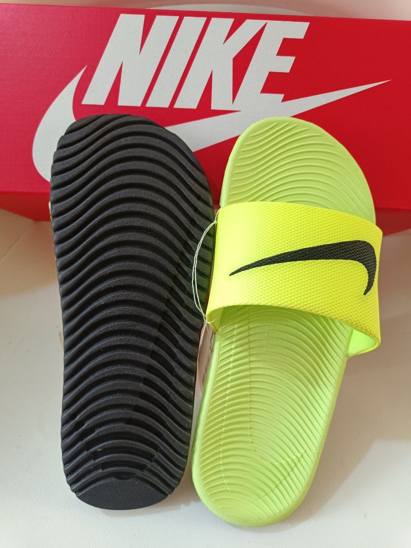 Nike Kawa Slide Sandals - 4Y (Category: Babies & Kids Fashion) located in Cavite. Submitted by disyc (Listing ID 1422381772, Image 2). Description: - Authentic Nike Kawa Slide sandals - Neon green color - Size: 4Y - Includes original box and tags - Features Nike swoosh logo - Textured footbed for comfort - Durable sole for grip - Ideal for casual wear and post-sports activities.