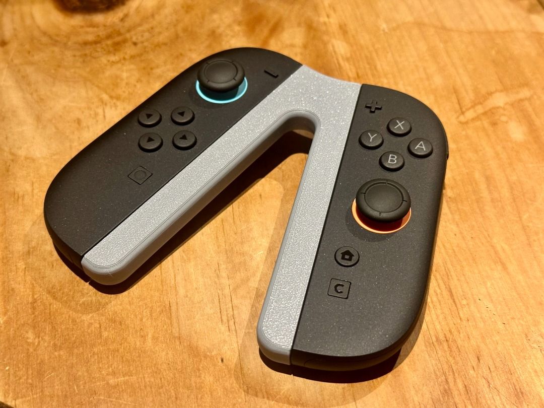 Nintendo Switch Joy-Con Compact Grip | Single Controller Comfort Handle | Red/Blue (Category: Controllers) located in Mandaluyong City. Submitted by heyitslaaaance (Listing ID 1422239503, Image 3). Description: Level up your multiplayer game with this Compact Joy-Con Controller Grip. If you find the bare Joy-Con too small for your hands during long sessions, this grip adds the extra "meat" and ergonomics you need for a more natural feel. It’s des