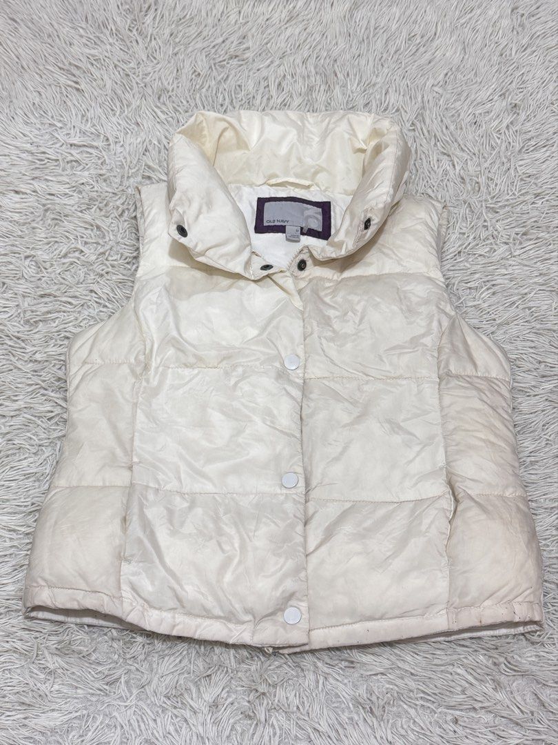 Old Navy Puffer Vest - Cream (Category: Vests) located in Manila. Submitted by livelaughlovejay (Listing ID 1422375839, Image 1). Description: - Cream-colored Old Navy puffer vest - Size: Medium - Features a high collar - Button closure - Quilted design - Perfect for layering - Versatile style.