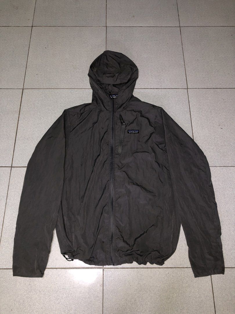 Patagonia Lightweight Jacket with Hood (Category: Coats, Jackets and Outerwear) located in San Francisco. Submitted by thriftraphy (Listing ID 1422297806, Image 2). Description: - Patagonia jacket, size Large - Full zip closure - Attached hood - Solid grey color - Lightweight design - Patagonia logo on chest - Drawstring at bottom hem - Made in Nicaragua.