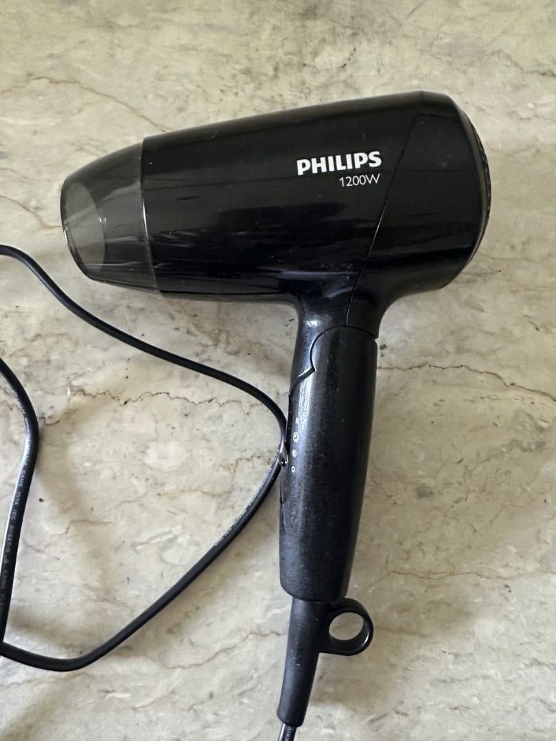 Philips 1200W Hair Dryer (Category: Hair) located in Pasig City. Submitted by lawsoneleven (Listing ID 1422241628, Image 2). Description: - I'm a guy with short hair and barely used this. Only when fixing hair for special occasions. - Black Philips hair dryer - 1200W power - Multiple heat settings - Includes concentrator nozzle - Features a storage loop.