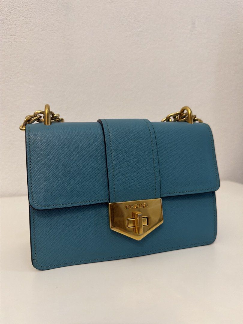Prada Diagramme Shoulder Bag (Category: Luxury Bags & Wallets) located in Manila. Submitted by justabagxoxo (Listing ID 1422278241, Image 2). Description: - Prada Diagramme shoulder bag - Stunning teal color - Elegant gold-tone hardware - Stylish chain strap - Secure flap closure with Prada logo - Luxurious teal leather interior - Structured shape - Versatile for everyday or special events .