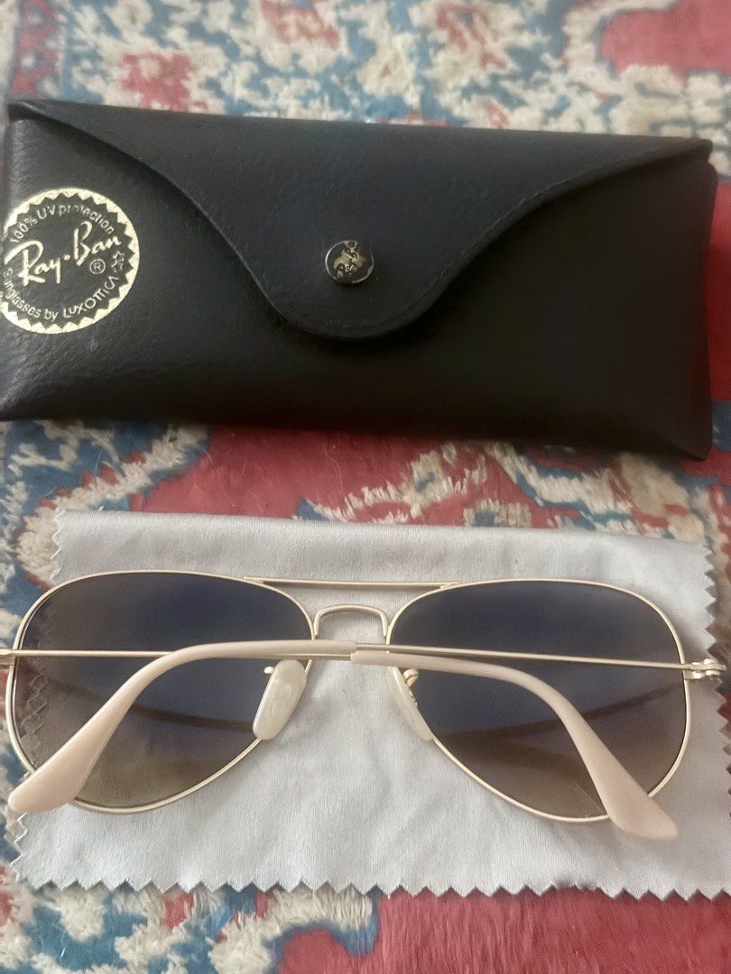 Ray-Ban Aviator Sunglasses (Category: Sunglasses & Eyewear) located in Dasmarinas. Submitted by 2018_jac (Listing ID 1422264145, Image 3). Description: - Authentic Ray-Ban Aviator sunglasses - Gold frame - Brown gradient lenses - Includes original case - Includes cleaning cloth - Includes paperwork - Ray-Ban logo visible - Classic and stylish accessory.