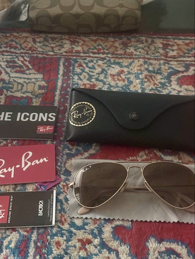 Ray-Ban Aviator Sunglasses (Category: Sunglasses & Eyewear) located in Dasmarinas. Submitted by 2018_jac (Listing ID 1422264145, Image 1). Description: - Authentic Ray-Ban Aviator sunglasses - Gold frame - Brown gradient lenses - Includes original case - Includes cleaning cloth - Includes paperwork - Ray-Ban logo visible - Classic and stylish accessory.