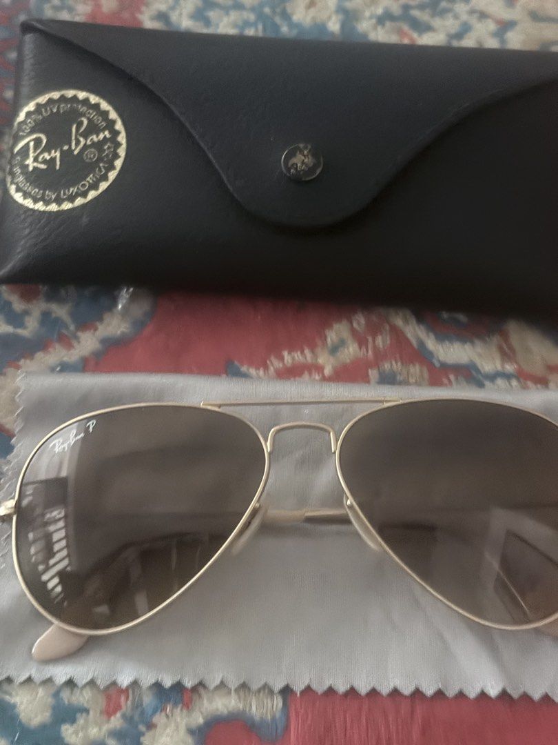 Ray-Ban Aviator Sunglasses (Category: Sunglasses & Eyewear) located in Dasmarinas. Submitted by 2018_jac (Listing ID 1422264145, Image 2). Description: - Authentic Ray-Ban Aviator sunglasses - Gold frame - Brown gradient lenses - Includes original case - Includes cleaning cloth - Includes paperwork - Ray-Ban logo visible - Classic and stylish accessory.