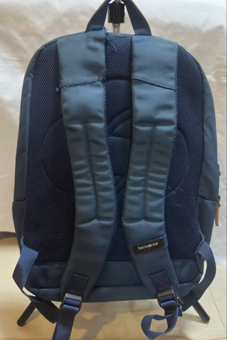 Samsonite Red Backpack (Category: Backpacks) located in San Pablo. Submitted by donaya_luxe (Listing ID 1422307696, Image 2). Description: Samsonite Red backpack features a navy blue exterior with brown leather accents. It has multiple compartments, including a padded laptop sleeve. The back panel is made of breathable mesh for comfort. The backpack has adjustable shoulder straps and a top handle. The interior lining is navy blue with the Samsoni