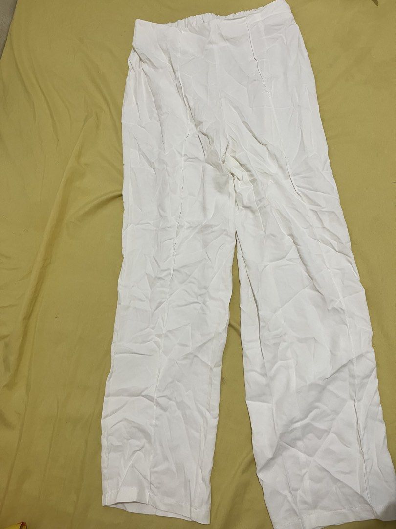Shein White Wide Leg Pants - Size L (Category: Other Bottoms) located in San Mateo. Submitted by closetnitata (Listing ID 1422344902, Image 2). Description: STRETCHABLE CAN FIT TO 33-36 waist - Shein white wide-leg pants - Size: L - Features an elastic waistband - Made in China - Simple design, ideal for casual wear - Lightweight and comfortable fabric.