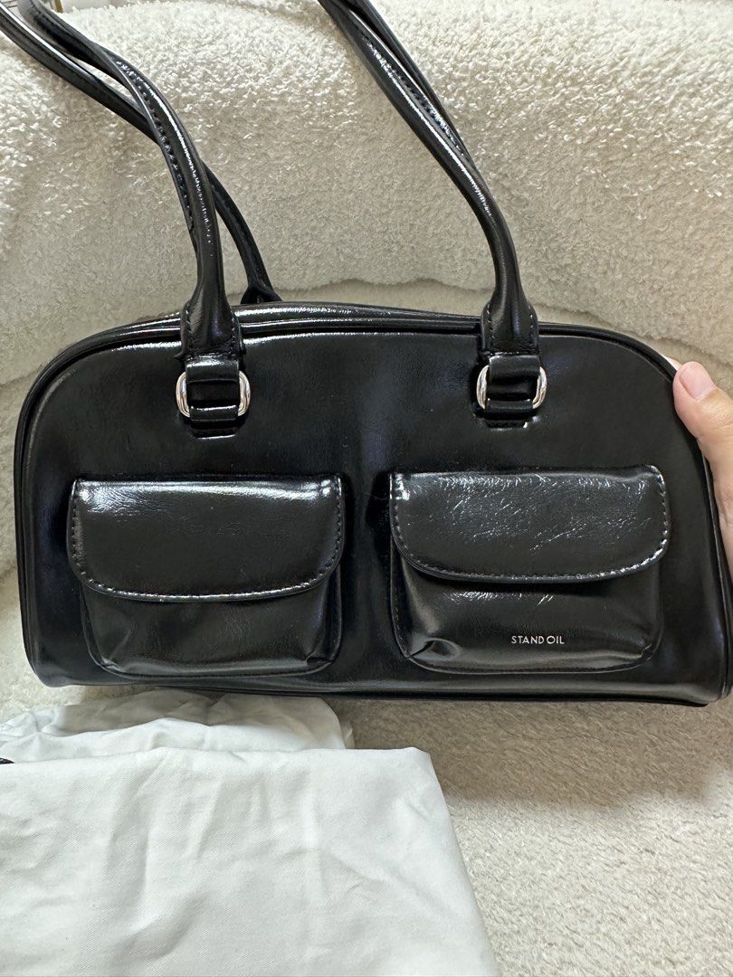 Stand Oil Boston Bag (Category: Luxury Bags & Wallets) located in Cavite. Submitted by luxedesign25 (Listing ID 1413067563, Image 3). Description: - Black Stand Oil Boston bag - Two front pockets - Top zipper closure - Two handles - Includes dust bag -authentic bag from korea.