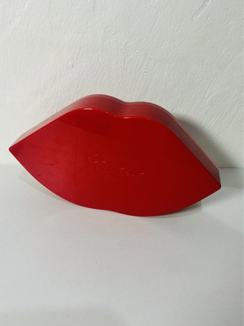 Strokes Red Lips Shaped Storage Box (Category: Storage Boxes & Baskets) located in Quezon City. Submitted by klawdeclutteeeeerr (Listing ID 1422278690, Image 2). Description: - Unique storage box shaped like red lips - Spacious interior for makeup, jewelry, or small items - Made of glossy red material - Smooth finish - Stylish and functional design - Adds a pop of color to any space - Decorative and practical.