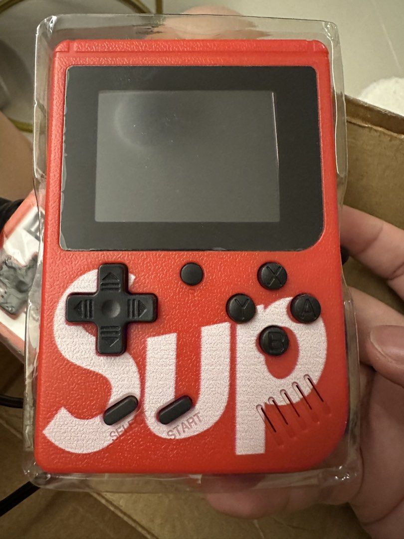 Sup Game Box 400 in 1 (Category: Nintendo) located in Quezon City. Submitted by smurkyjam23 (Listing ID 1422276979, Image 2). Description: - Sup Game Box Plus! - 400 built-in retro games. - Includes console, external gamepad, and AV cables. - Red console with Sup logo. - Supports 2-player gaming with external gamepad. - have not used for a year or so, on and off issue. Possibly need to change the battery.