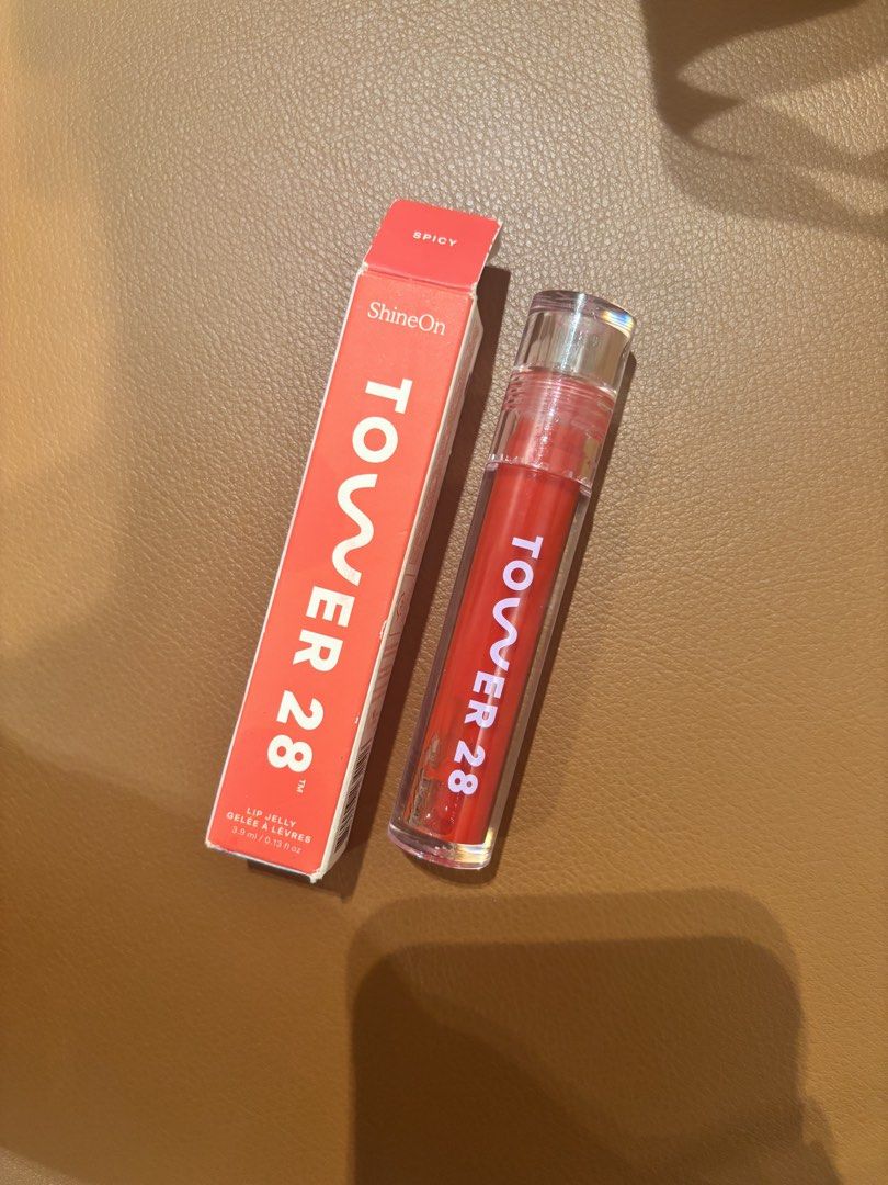 Tower 28 ShineOn Lip Jelly - Spicy (Category: Makeup) located in Makati City. Submitted by luxuryfinds88 (Listing ID 1422243096, Image 1). Description: - Tower 28 ShineOn Lip Jelly in Spicy - New, with original packaging - 3.9ml / 0.13 fl oz - Glossy finish - Red packaging with white text.