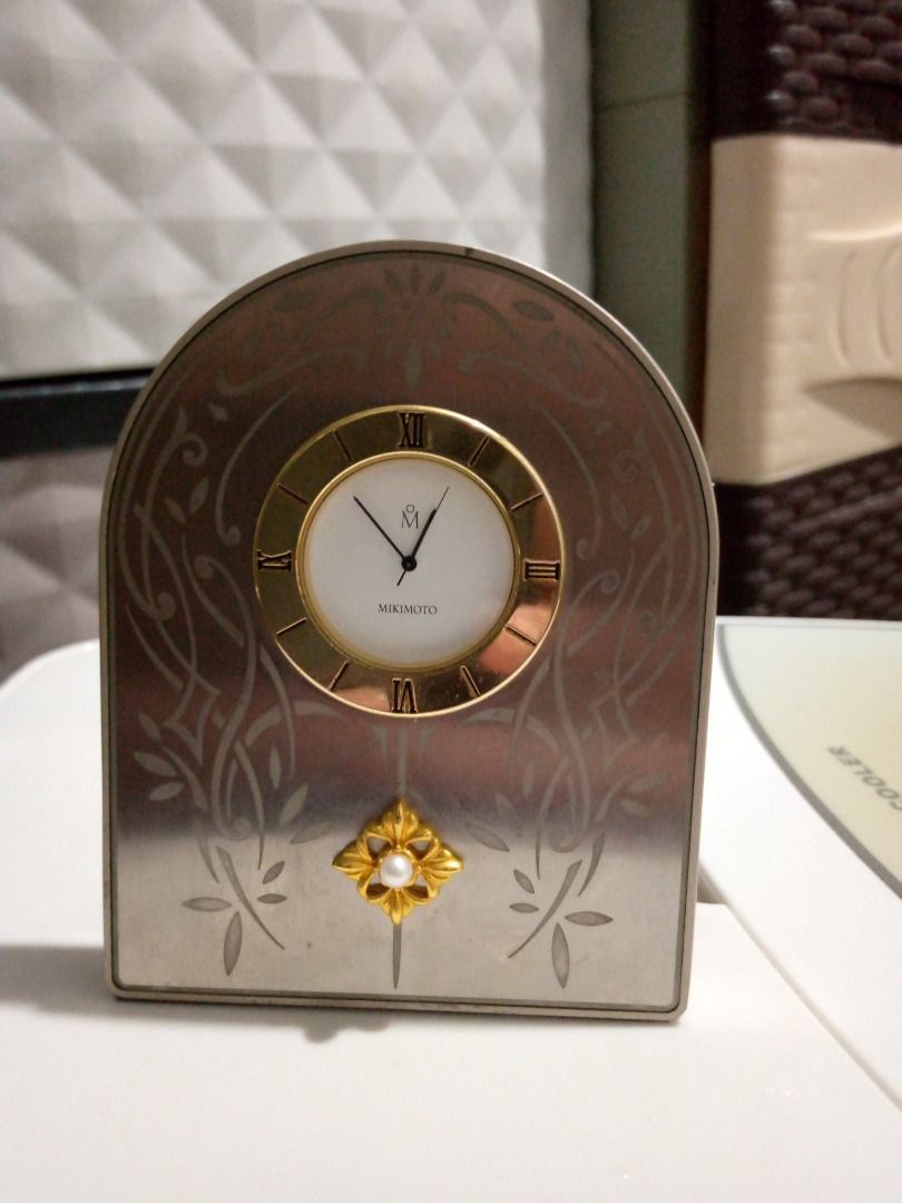 Vintage Mikimoto Decorative Clock (Category: Clocks) located in Imus. Submitted by chadrich_05 (Listing ID 1422385147, Image 3). Description: Working with new battery - Mikimoto decorative clock - Gold-toned clock face - Roman numerals - Pearl accent - Silver-toned frame with floral designs - Displays the Mikimoto logo - Perfect for display.