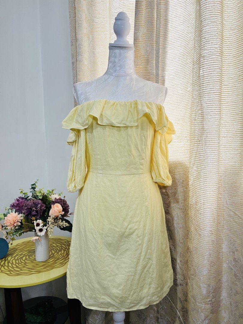 Yellow Off-Shoulder Ruffle Dress (Category: Dresses) located in Cebu City. Submitted by zinzitro (Listing ID 1422322833, Image 2). Description: - Cheerful yellow off-shoulder dress - Features ruffle detailing - Short, puffy sleeves - Size: Small-Large - Made of lightweight fabric - Ideal for warmer weather - Suitable for various occasions.