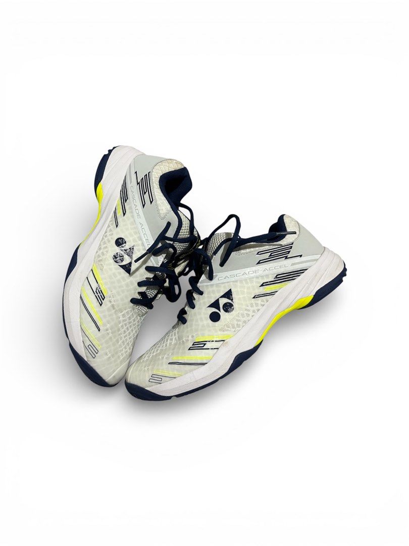 Yonex Cascade Accel Badminton Shoes (Category: Sneakers) located in Batangas. Submitted by thrift.with.okiks (Listing ID 1422355295, Image 1). Description: - Yonex Cascade Accel badminton shoes - Color: White, yellow, and navy blue - Mesh upper for breathability - Durable sole for grip - Yonex logo visible.