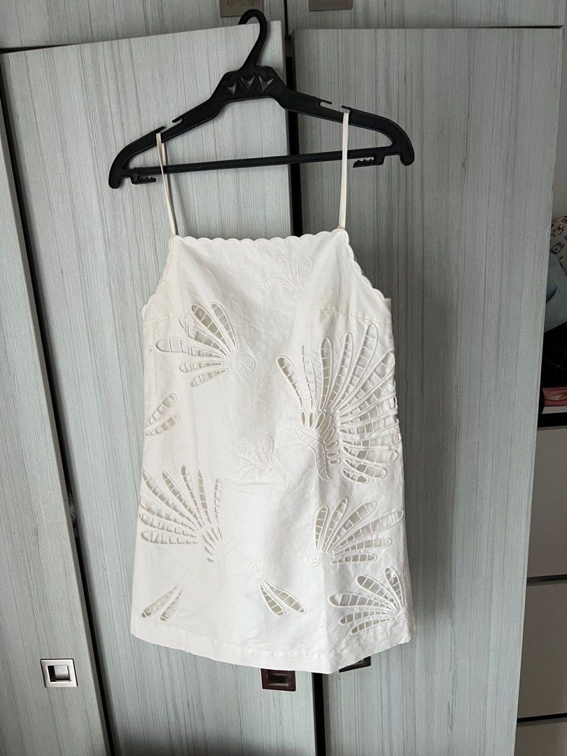 Zara White Embroidered Mini Dress (Category: Dresses) located in Mandaluyong City. Submitted by basic.coex (Listing ID 1422307598, Image 1). Description: - White mini dress - Intricate embroidered details - Square neckline - Thin straps - Scalloped edge - Fan-like embroidery pattern - Lightweight fabric.