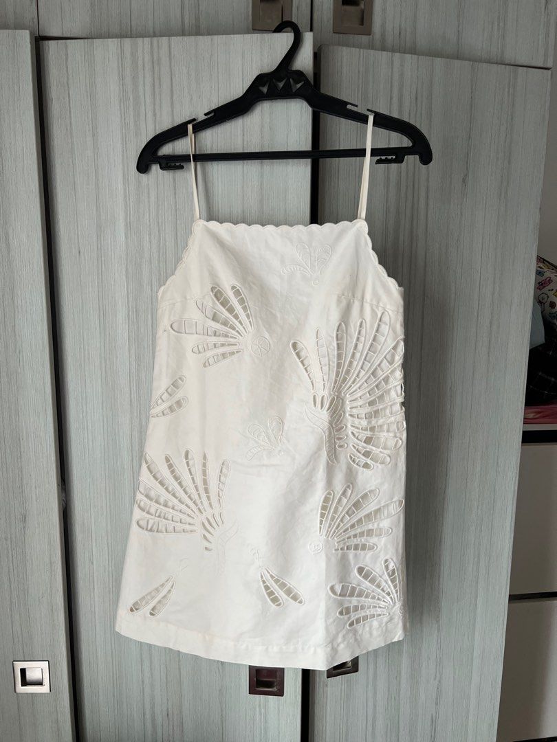 Zara White Embroidered Mini Dress (Category: Dresses) located in Mandaluyong City. Submitted by basic.coex (Listing ID 1422307598, Image 2). Description: - White mini dress - Intricate embroidered details - Square neckline - Thin straps - Scalloped edge - Fan-like embroidery pattern - Lightweight fabric.