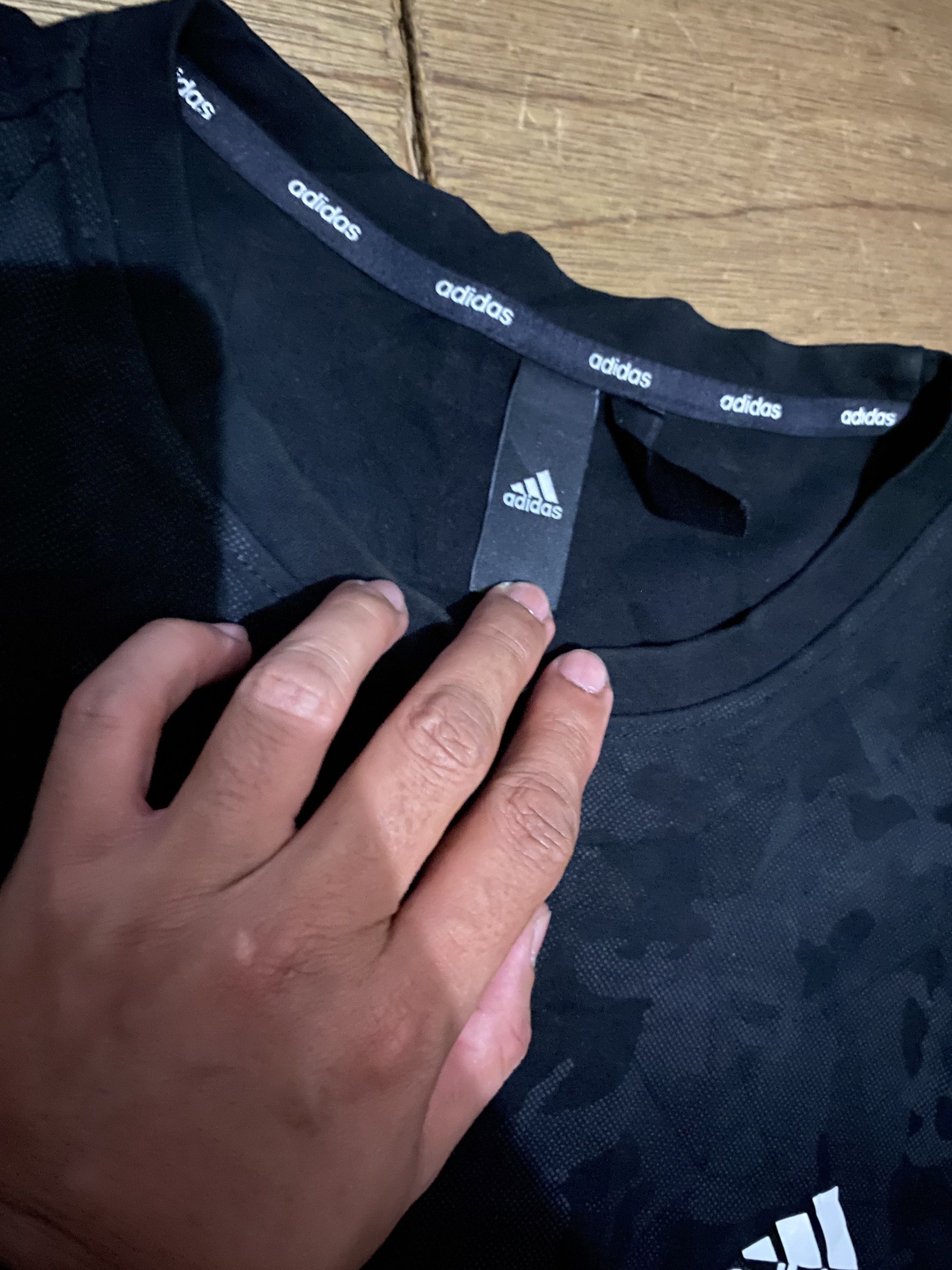 Adidas Camo Crewneck Sweatshirt (Category: Coats, Jackets and Outerwear) located in Cavite. Submitted by jamstore89 (Listing ID 1419365956, Image 3). Description: Fs Black Adidas crewneck sweatshirt with a camo pattern. Size : Xl Dimes : 24x28" Location: paranaque P500 Features the Adidas logo on the chest. The tag shows the Adidas logo and other details. The sweatshirt has a ribbed collar, cuffs, and hem..