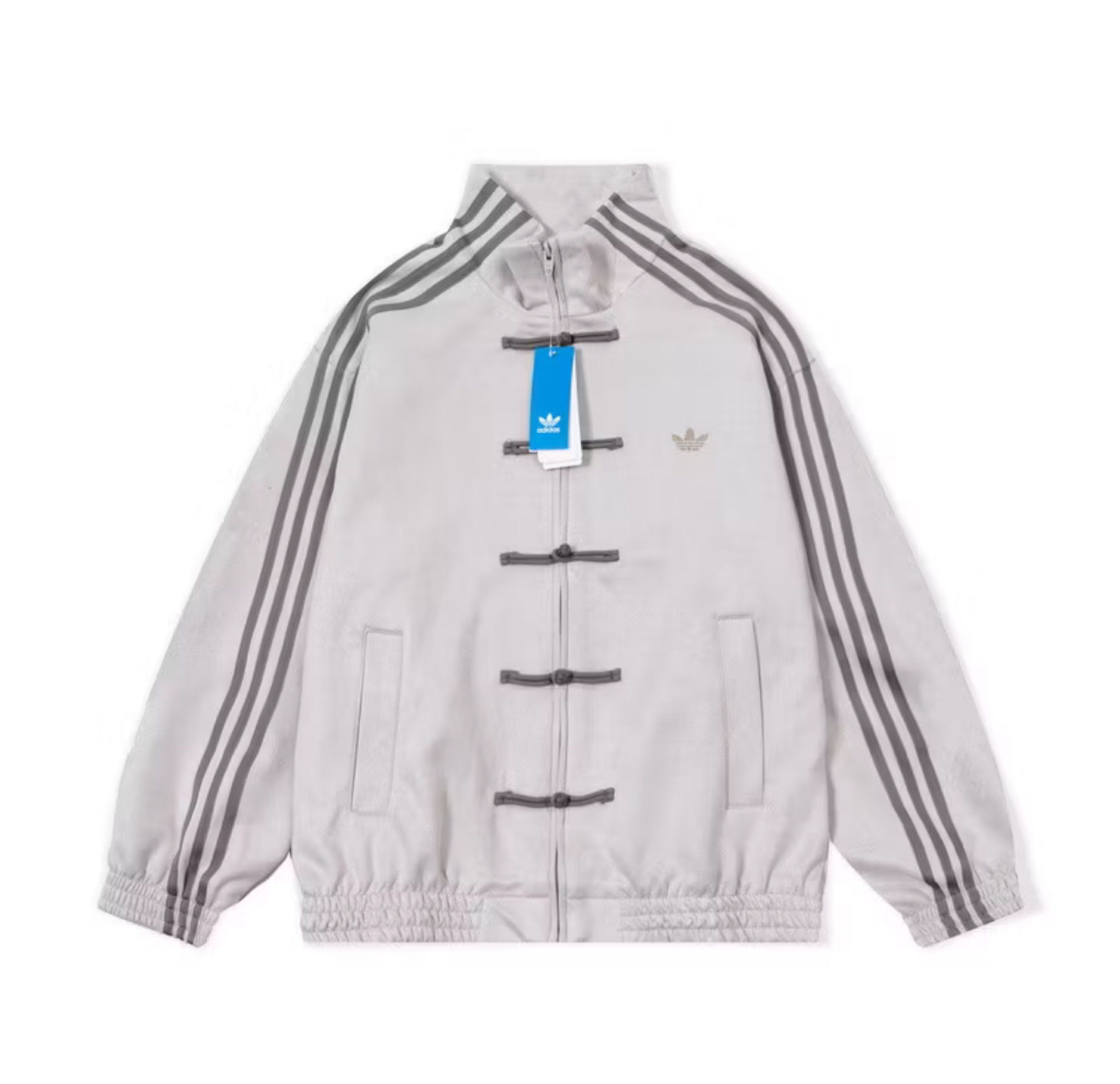 Adidas Chinese Style Jacket (Category: Coats, Jackets and Outerwear) located in Balayan. Submitted by charlesram56892 (Listing ID 1419197436, Image 3). Description: - Adidas jacket with a unique Chinese-inspired design. - Stand-up collar and zipper closure. - Distinctive frog closures. - Iconic three stripes on the sleeves. - Available in multiple colors. - Adds a touch of cultural flair to your style..