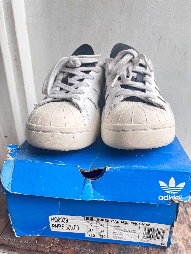 Adidas Superstar Millencon W Sneakers (Category: Sneakers) located in Pasig City. Submitted by wangderfulworld (Listing ID 1419221513, Image 2). Description: - Adidas Superstar Millencon W Sneakers - Authentic, bought in Podium - White with black accents - Size: US 6, EUR 37 1/2, 23cm - Includes original box - Classic Adidas stripes - Soles show some wear - Box has some wear and tear - Orig price (₱5,800).