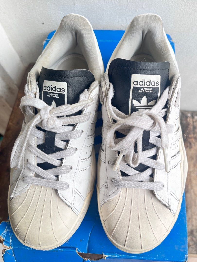Adidas Superstar Millencon W Sneakers (Category: Sneakers) located in Pasig City. Submitted by wangderfulworld (Listing ID 1419221513, Image 1). Description: - Adidas Superstar Millencon W Sneakers - Authentic, bought in Podium - White with black accents - Size: US 6, EUR 37 1/2, 23cm - Includes original box - Classic Adidas stripes - Soles show some wear - Box has some wear and tear - Orig price (₱5,800).