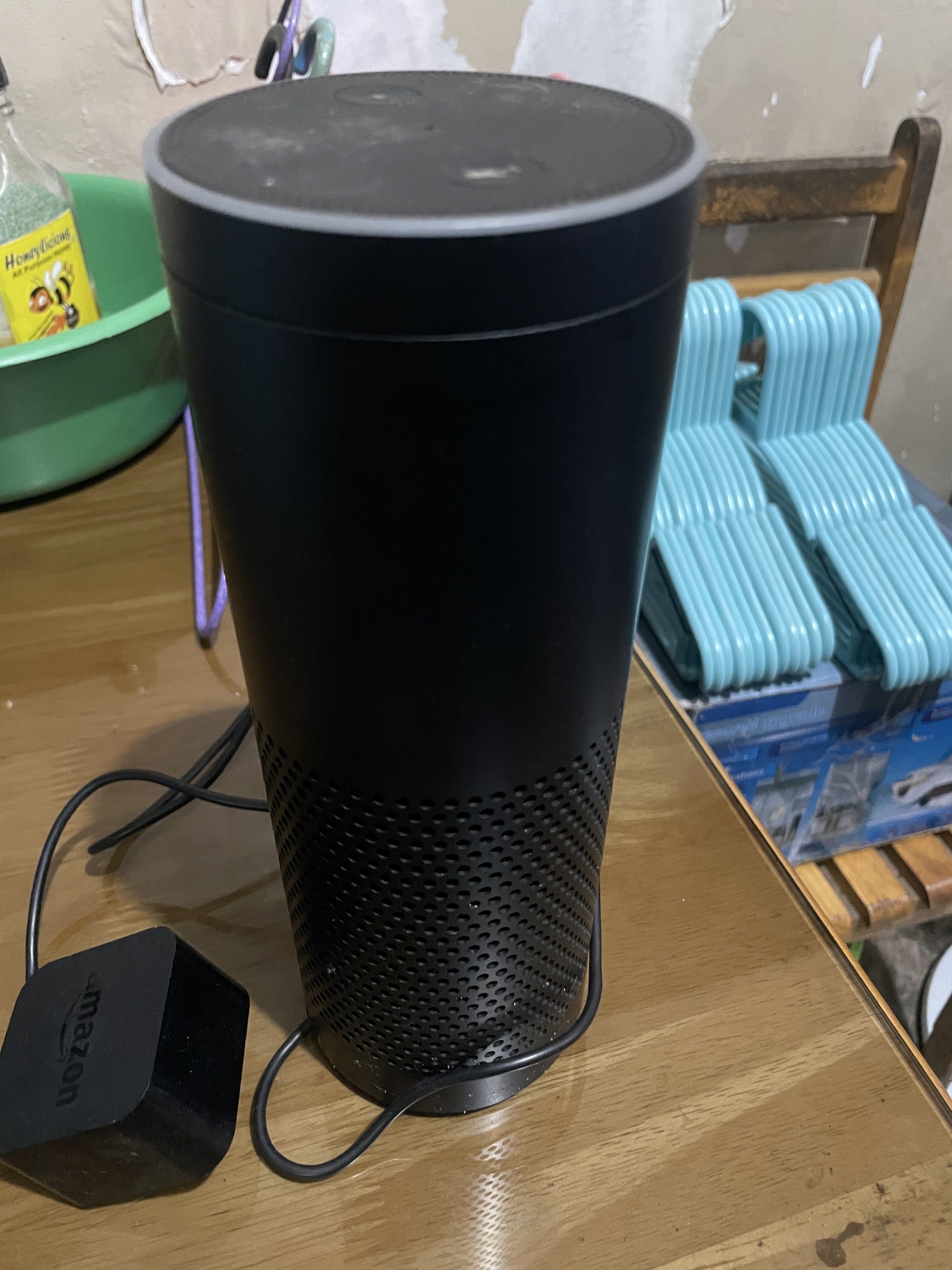 Amazon Echo (Category: Soundbars, Speakers & Amplifiers) located in Manila. Submitted by cosmiccloud-adf7 (Listing ID 1419256186, Image 2). Description: - Amazon Echo smart speaker - Color: Black - Includes power adapter - Features top buttons and microphone icon - Cylindrical design - Fabric-like texture on the bottom half.
