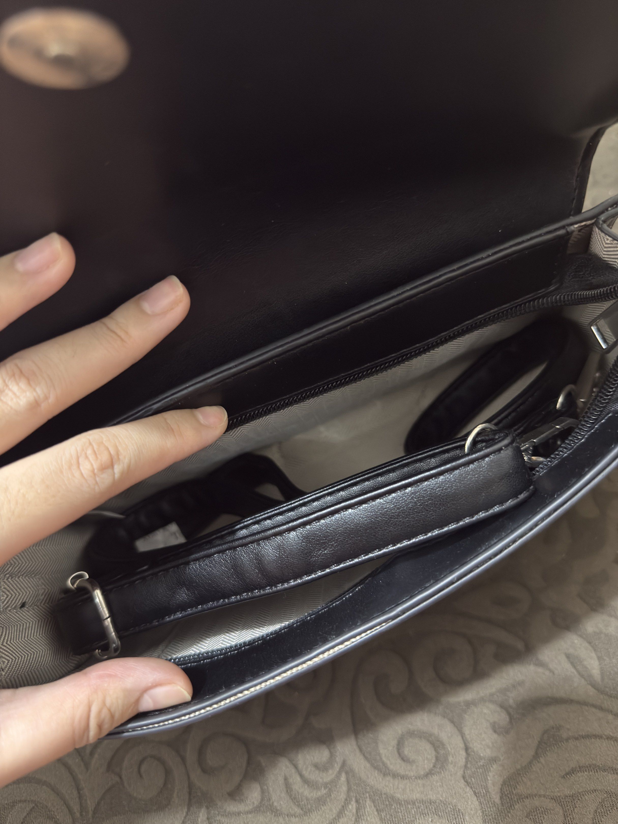 Black Handbag with Circular Handle (Category: Luxury Bags & Wallets) located in Quezon City. Submitted by quickmoon_3a73ae (Listing ID 1419217064, Image 2). Description: - Black handbag - Unique circular handle - Rectangular body with flap closure - Interior zippered pocket - Detachable strap - Smooth, leather-like material - Stylish for everyday use.