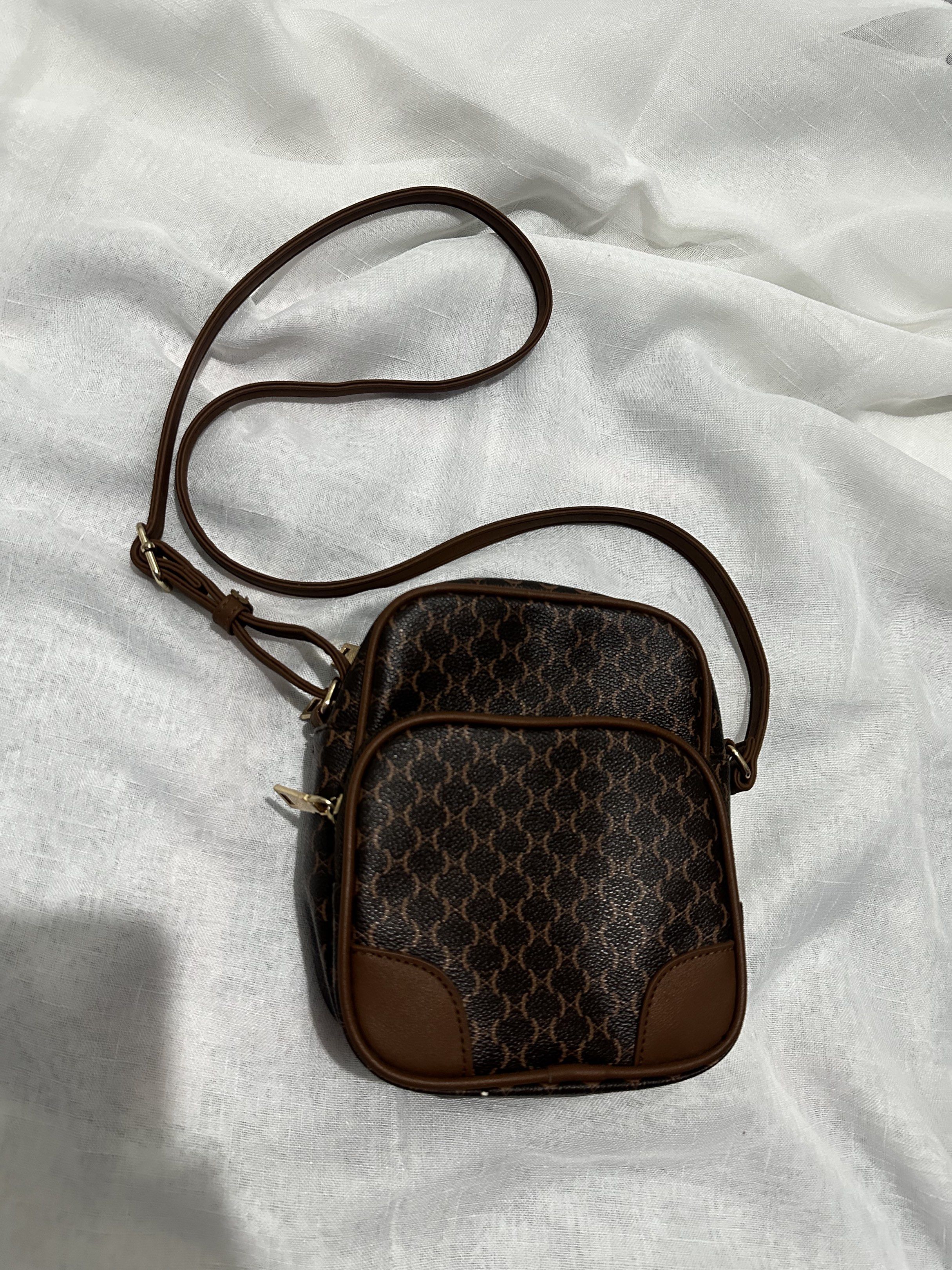 Brown Patterned Crossbody Bag (Category: Cross-body Bags) located in Pasay City. Submitted by j9declutter (Listing ID 1419332954, Image 3). Description: Decluttering! Selling low!!! Pick-up via grab/move it/joyride/angkas/lalamove only. NO COD! If in doubt, wag bumili 😁 You can pay thru BPi & Gcash only. Happy shopping! ❤️❤️❤️ Got this from Japan. Leather bag. .