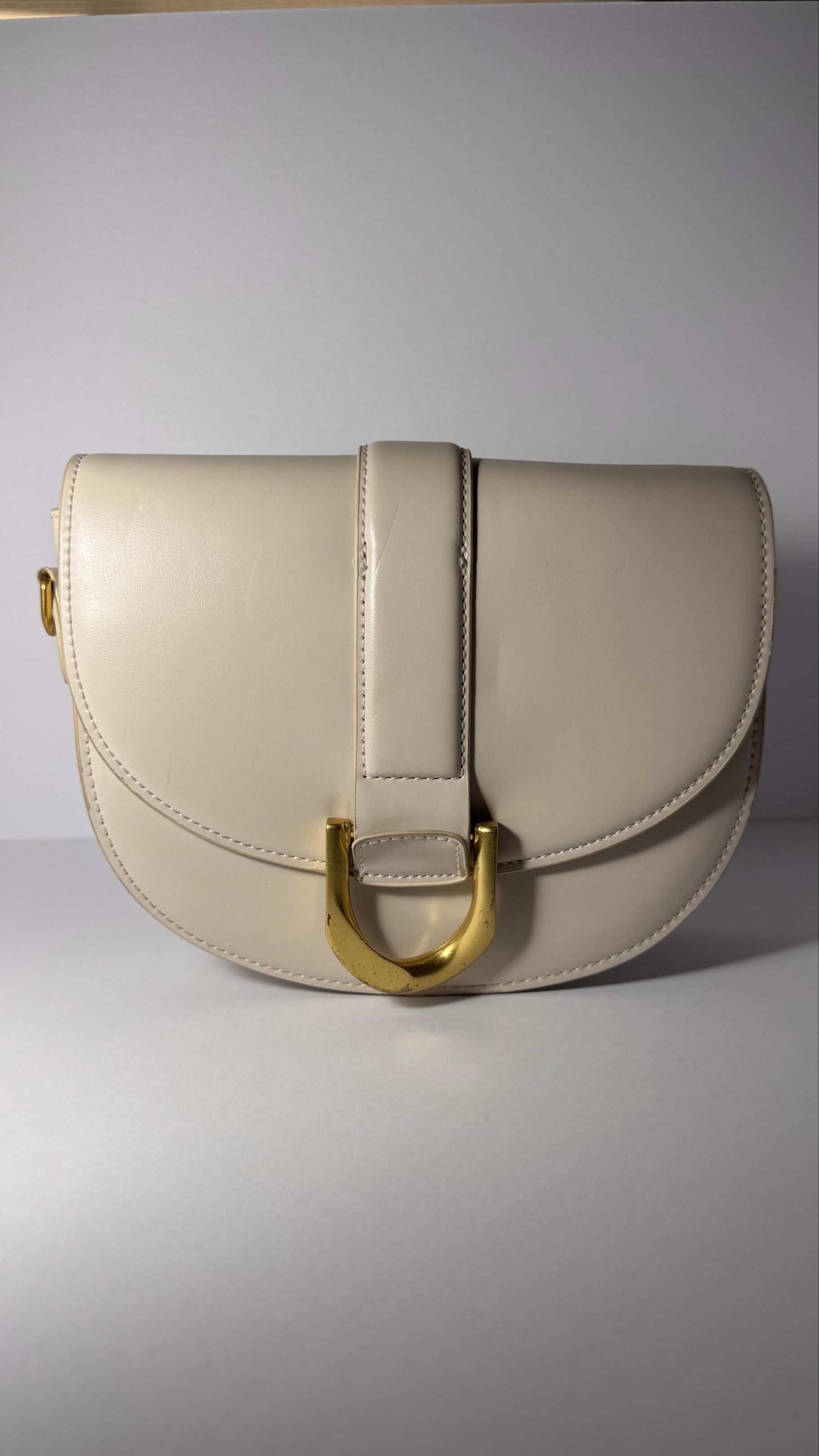 Charles & Keith Saddle Bag (Category: Luxury Bags & Wallets) located in Bacoor. Submitted by neoprelovedjapan (Listing ID 1419261412, Image 2). Description: PreLoved Charles & Keith saddle bag - Features gold-tone buckle and hardware - Includes detachable shoulder strap - Flap closure - Spacious interior - Original tags included - Charles & Keith logo visible.