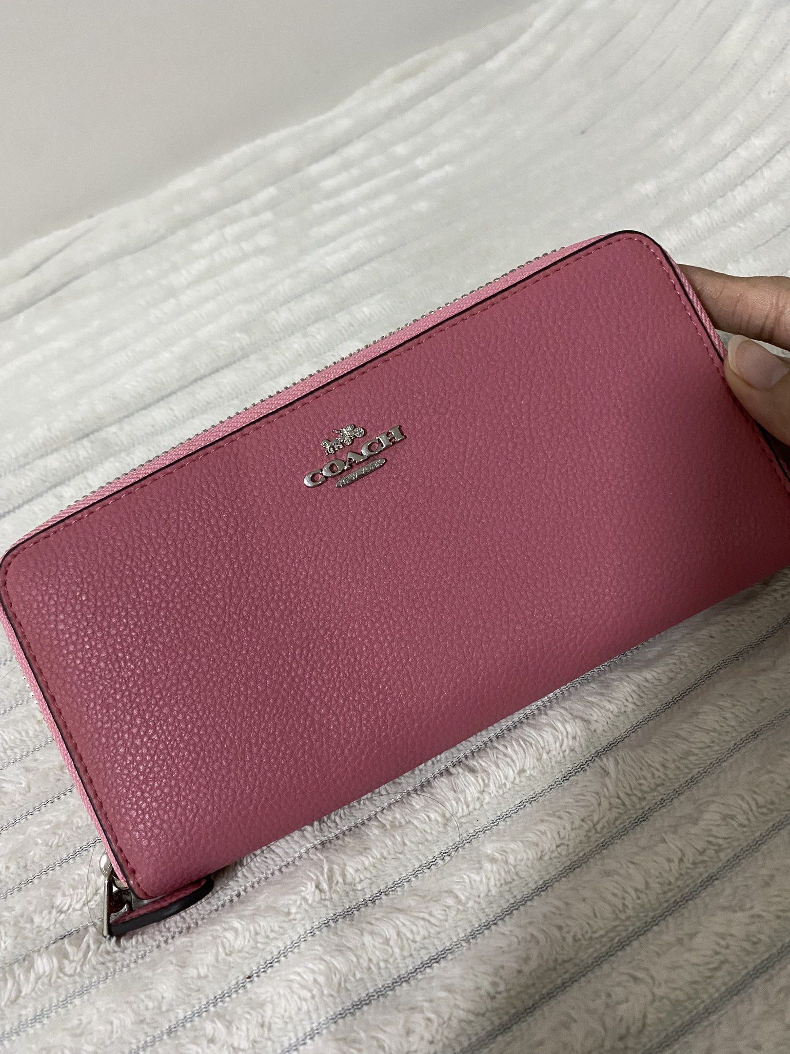 Coach Zip Around Pink Wallet (Category: Luxury Bags & Wallets) located in Santa Rosa. Submitted by sassycollection. (Listing ID 1419383015, Image 1). Description: - Authentic Coach wallet - Zip-around closure - Pink color - Multiple card slots and compartments - Made in Vietnam - Silver zipper - Coach logo on front.