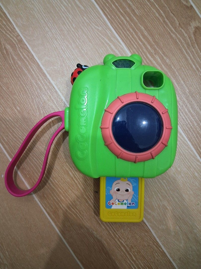 CoComelon Toy Camera (Category: Cameras) located in Manila. Submitted by austincaleb18 (Listing ID 1419253329, Image 1). Description: FOR SALE - P300 Working Electronics. 8/10 Condition RFS: Nakadisplay nalang - CoComelon Toy Camera - Color: Green with pink strap - Features a blue lens - Includes a yellow card with a CoComelon character - Adorable ladybug detail on top - Designed for young children Pick up/Meet up: Labores Pandacan Manila or Glor