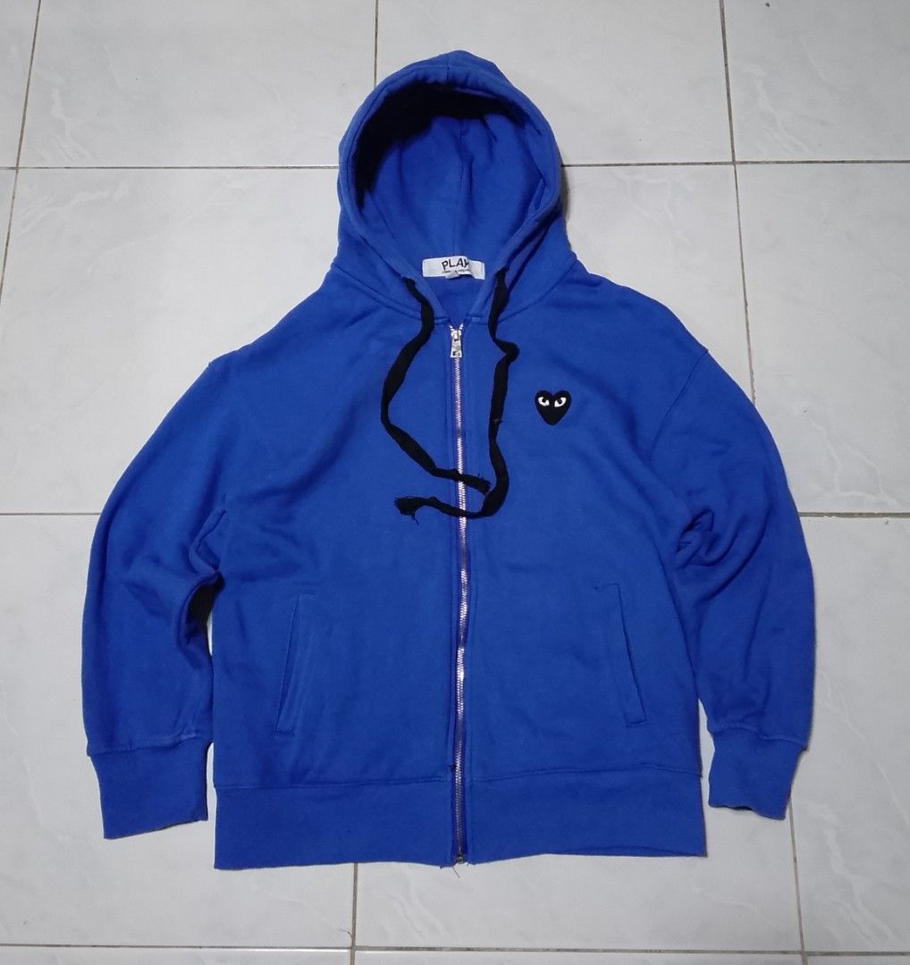 Comme des Garcons Play Hoodie - Blue (Category: Coats, Jackets and Outerwear) located in Manila. Submitted by moisky18 (Listing ID 1419223772, Image 1). Description: - Comme des Garcons Play hoodie - Color: Blue - Size: M - Full zip closure - Hood with black drawstrings - Two front pockets - Embroidered heart logo on chest.