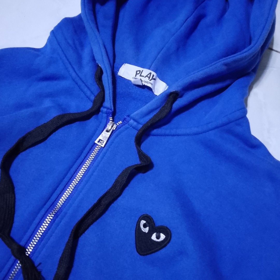 Comme des Garcons Play Hoodie - Blue (Category: Coats, Jackets and Outerwear) located in Manila. Submitted by moisky18 (Listing ID 1419223772, Image 2). Description: - Comme des Garcons Play hoodie - Color: Blue - Size: M - Full zip closure - Hood with black drawstrings - Two front pockets - Embroidered heart logo on chest.