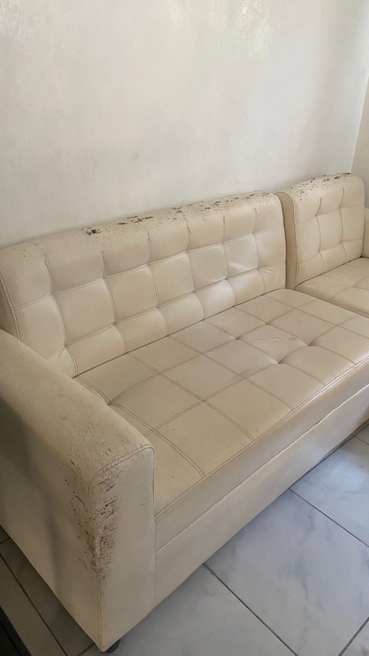 Cream-colored L-shaped Sofa Couch Leather (Category: Sofas) located in Quezon City. Submitted by ayreneeee (Listing ID 1419235474, Image 2). Description: - Cream-colored L-shaped sofa - Features a tufted design - Includes an attached chaise lounge - Made of faux leather material For upholstery & cleaning.