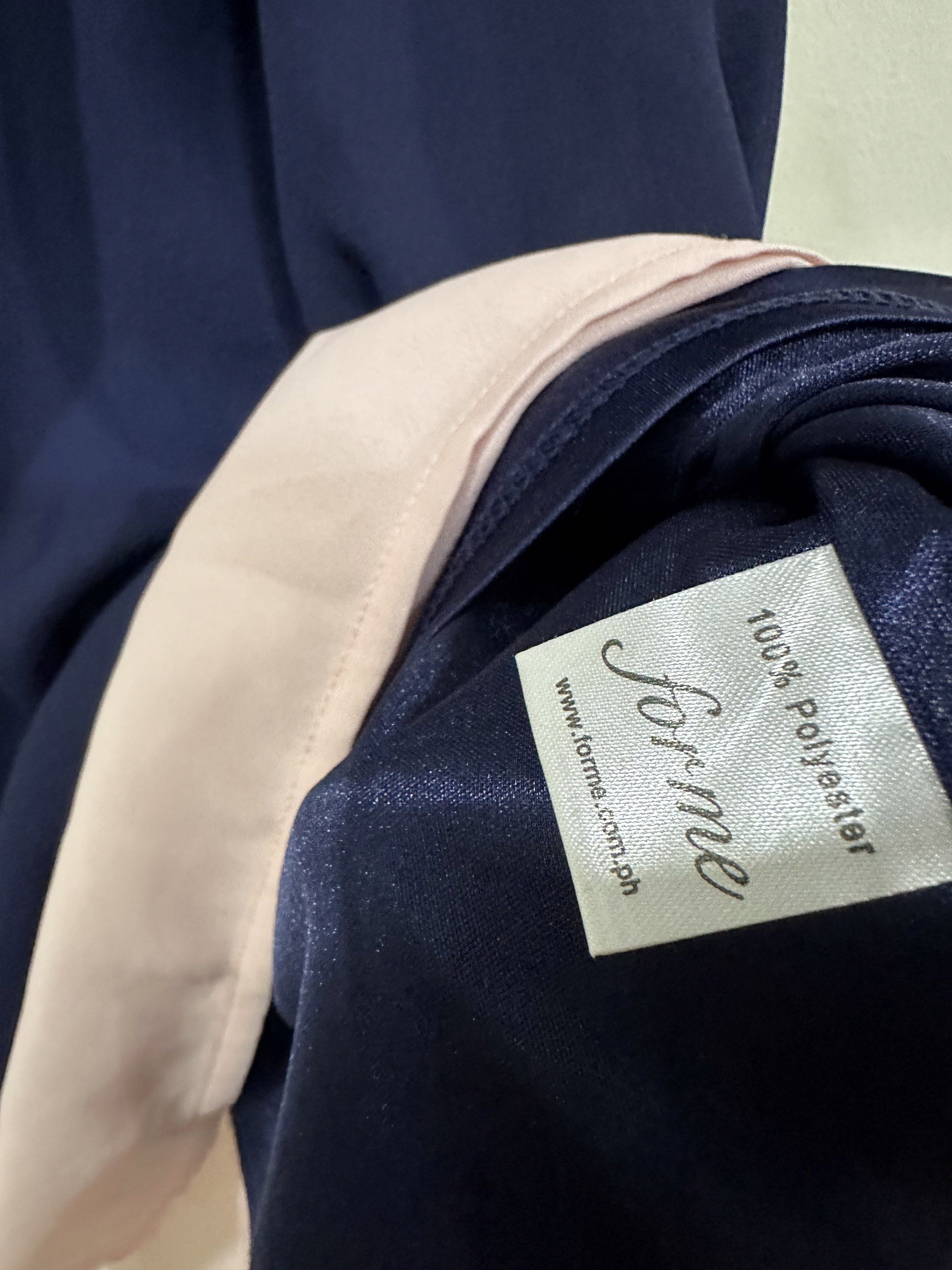 Forme Navy Blue and Pink Top (Category: Blouses) located in Quezon City. Submitted by declutter___mnl (Listing ID 1419273754, Image 2). Description: - Forme halter top - Navy blue with pink hem - Flowy design - Made of 100% polyester.