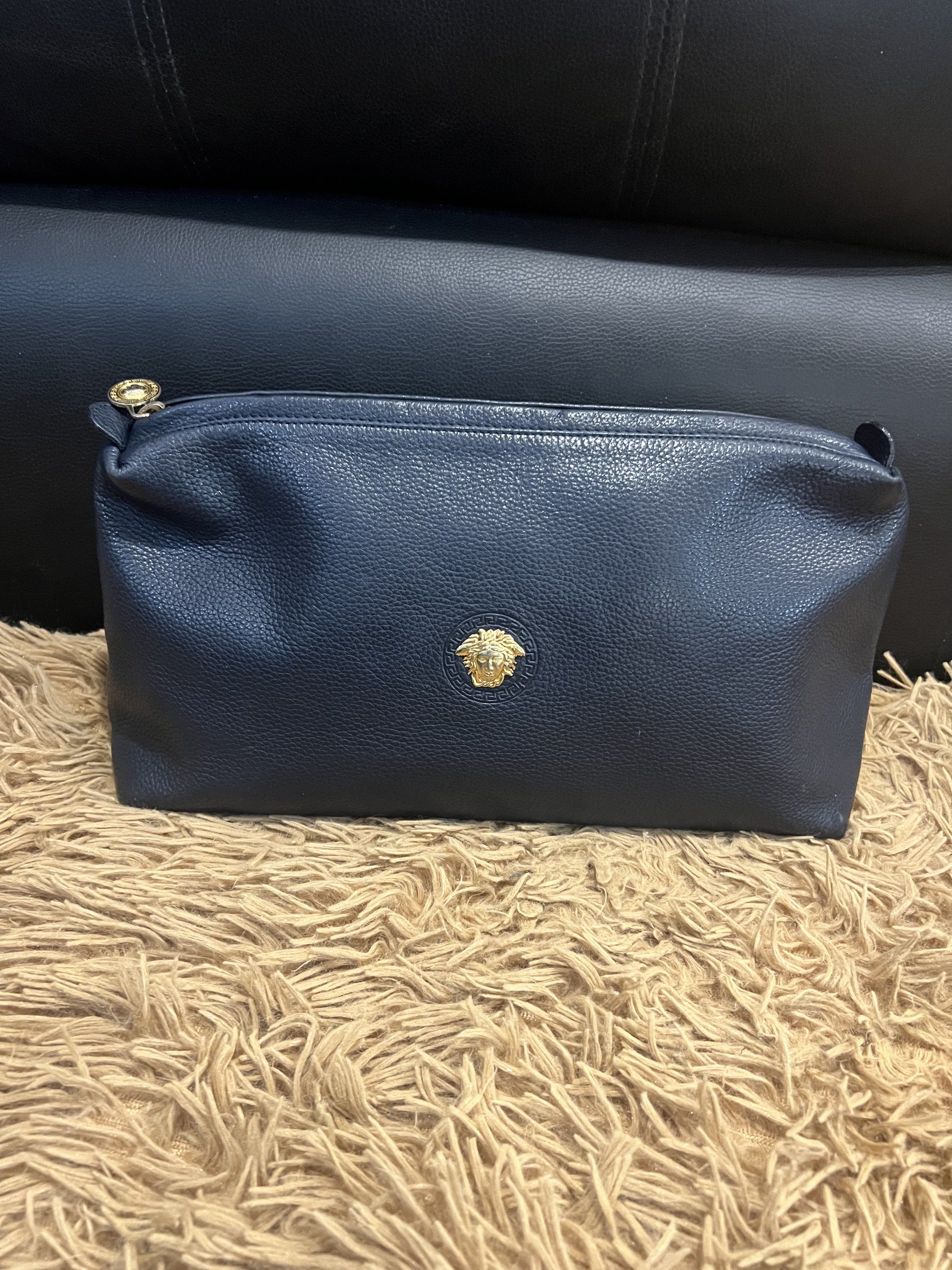 Gianni Versace Navy Clutch (Category: Luxury Bags & Wallets) located in Lipa City. Submitted by thyra06 (Listing ID 1419253983, Image 1). Description: - Gianni Versace navy clutch - Gold-tone Medusa head emblem - Gold-tone zipper pull with Versace logo - Rectangular shape - Made in Italy.