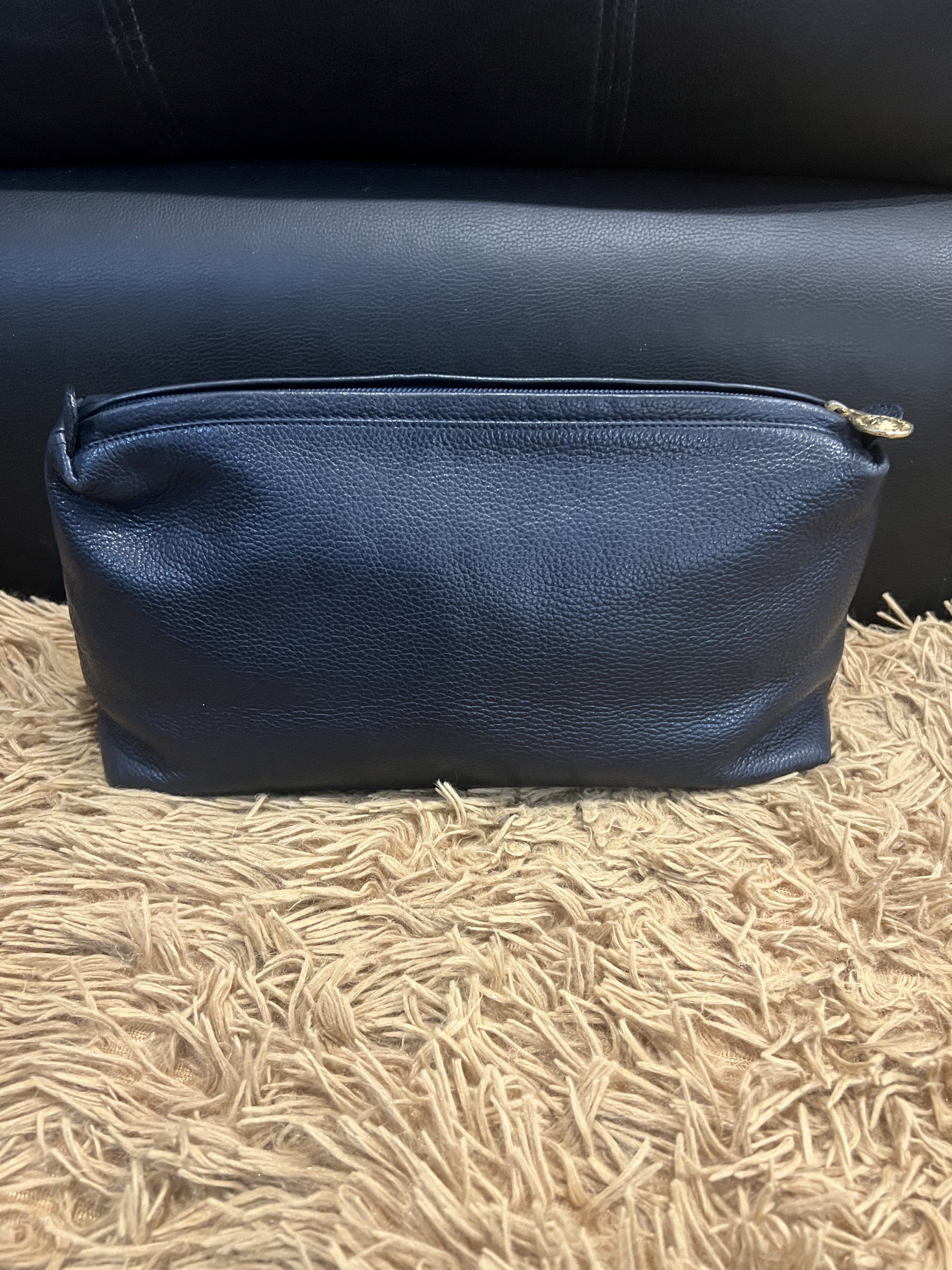 Gianni Versace Navy Clutch (Category: Luxury Bags & Wallets) located in Lipa City. Submitted by thyra06 (Listing ID 1419253983, Image 2). Description: - Gianni Versace navy clutch - Gold-tone Medusa head emblem - Gold-tone zipper pull with Versace logo - Rectangular shape - Made in Italy.