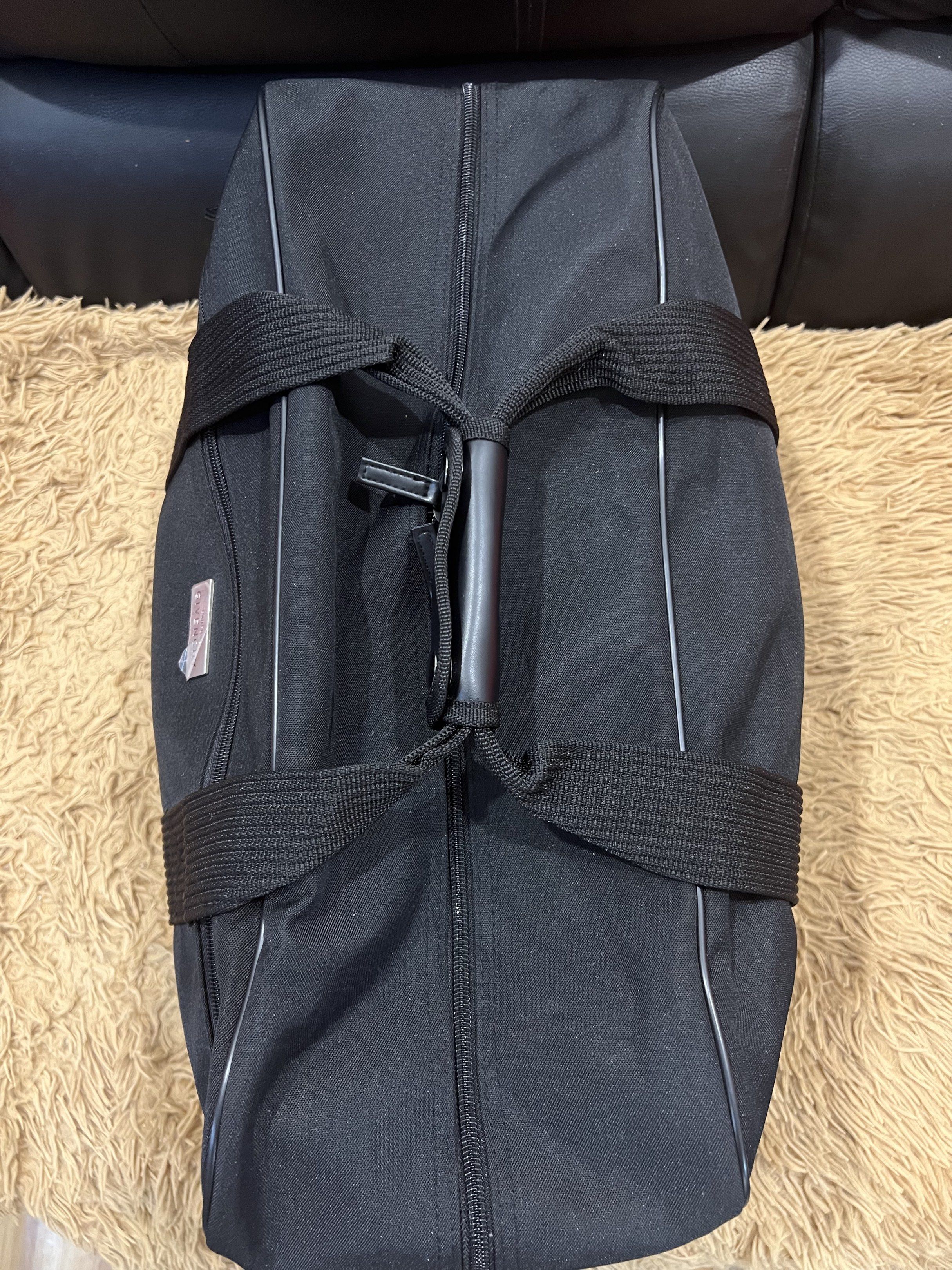 Givenchy Black Duffle Bag (Category: Luxury Bags & Wallets) located in Lipa City. Submitted by thyra06 (Listing ID 1419253554, Image 3). Description: - Authentic Givenchy duffle bag - Classic black color - Includes a detachable shoulder strap and top handles - Features the iconic Givenchy logo - Secure zippered main compartment - Constructed with durable materials.