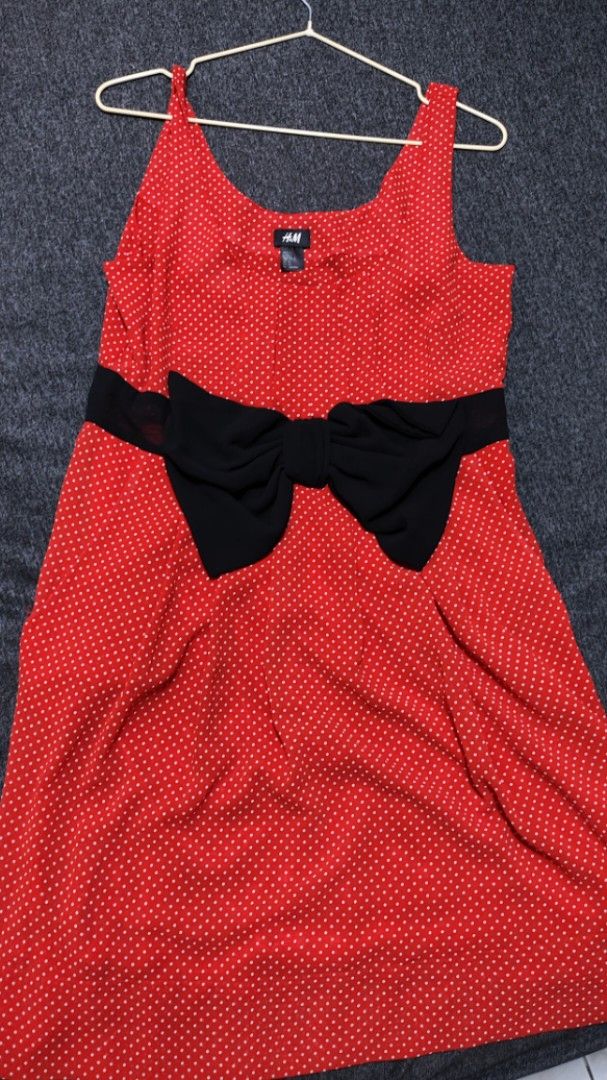H&M Red Polka Dot Dress with Bow (Category: Dresses) located in Caloocan City. Submitted by declutterwithcath (Listing ID 1419313252, Image 1). Description: - H&M red dress with white polka dots - Features a black bow at the waist - Sleeveless design - Scoop neckline - Flattering A-line silhouette - Knee-length - Made of lightweight fabric.