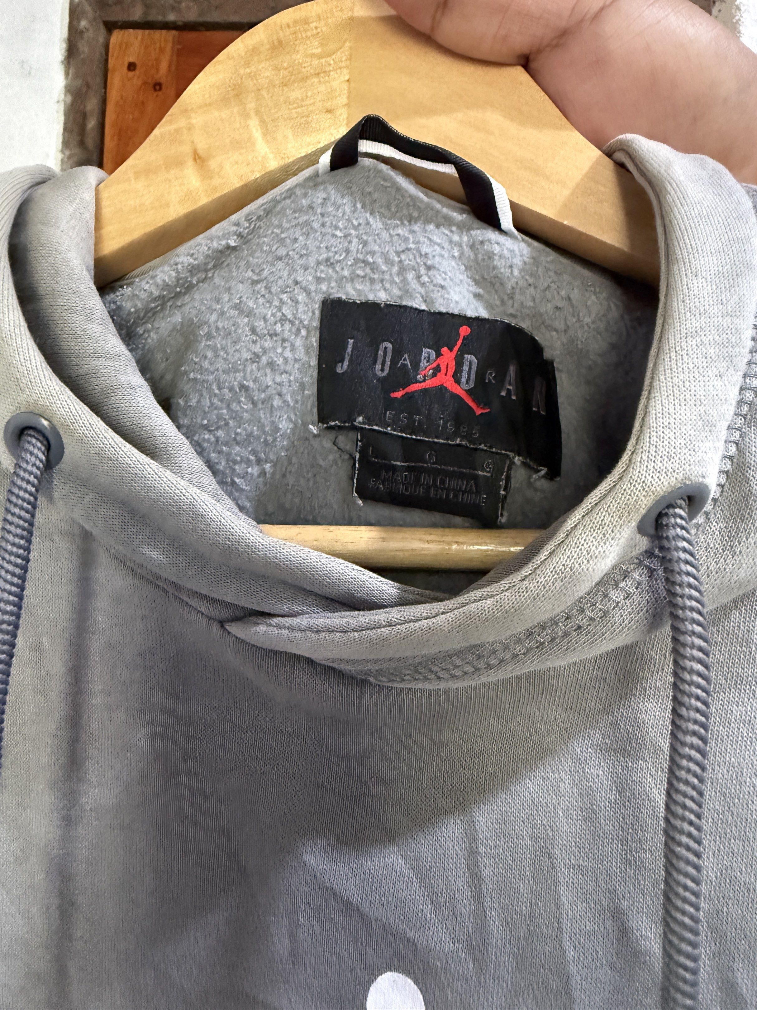 Jordan Hoodie - Gray (Category: Coats, Jackets and Outerwear) located in Manila. Submitted by keepercollection (Listing ID 1419204805, Image 2). Description: - Gray Nike Jordan hoodie - Iconic Jumpman logo on the front - Size G - Made in China - Material: 80% cotton, 20% polyester - Kangaroo pocket and drawstring hood - MJ23 Nike logo patch on the back.