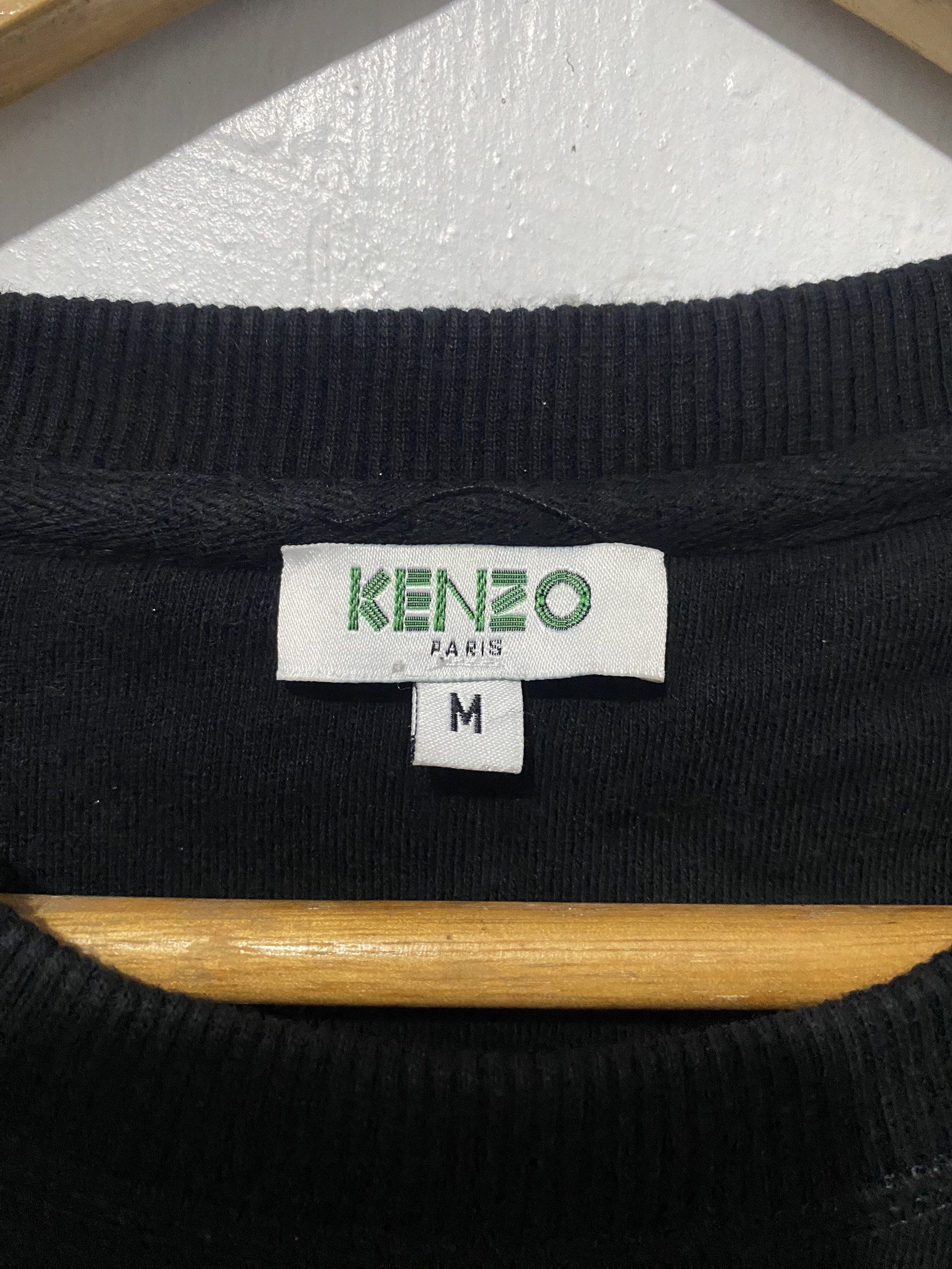 Kenzo Paris Tiger Sweatshirt - Black - Medium (Category: Coats, Jackets and Outerwear) located in Sorsogon. Submitted by ninjathrift (Listing ID 1419384006, Image 3). Description: - Authentic Kenzo Paris sweatshirt - Black color - Features the iconic tiger embroidery - Crew neck design - Size: Medium - Made in Portugal - Long sleeves - Visible care label - Embroidered Kenzo logo on the front -A bit of print issue in some letters of "KENZO".