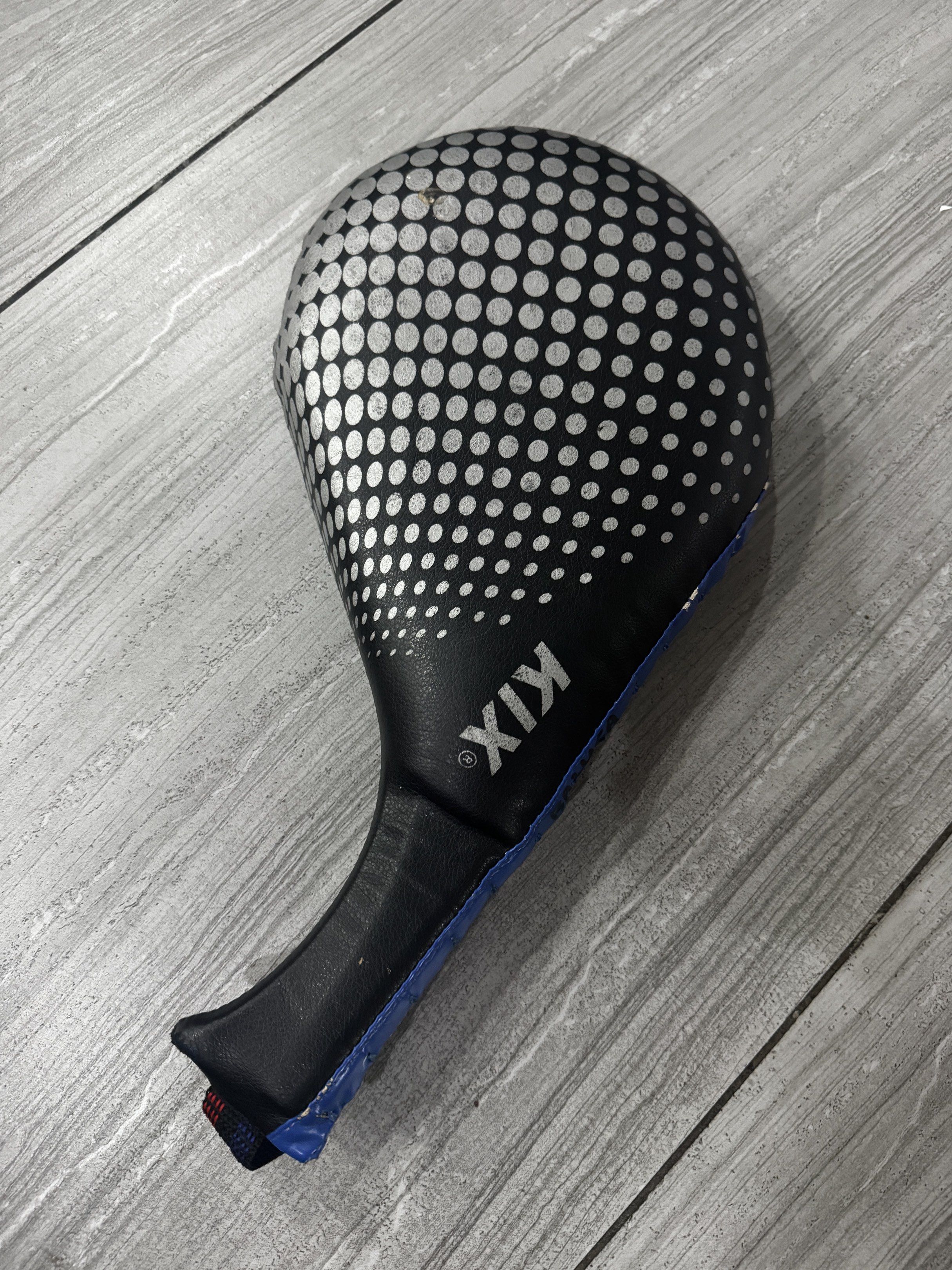 Kix Kick Pad (Category: Other Sports Equipment and Supplies) located in Quezon City. Submitted by aimee0913 (Listing ID 1419270906, Image 2). Description: - Black and blue kick pad - Features Nike and Kix logos - Designed for martial arts training - Includes a handle for easy grip - Built to absorb impact.