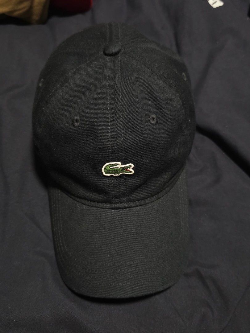 Lacoste Black Cap (Category: Caps & Hats) located in Quezon City. Submitted by yGGGG (Listing ID 1419245877, Image 2). Description: - Black Lacoste cap - Iconic crocodile logo - Curved brim - Adjustable strap - Green Lacoste branded taping inside - Made in Vietnam - Durable fabric.