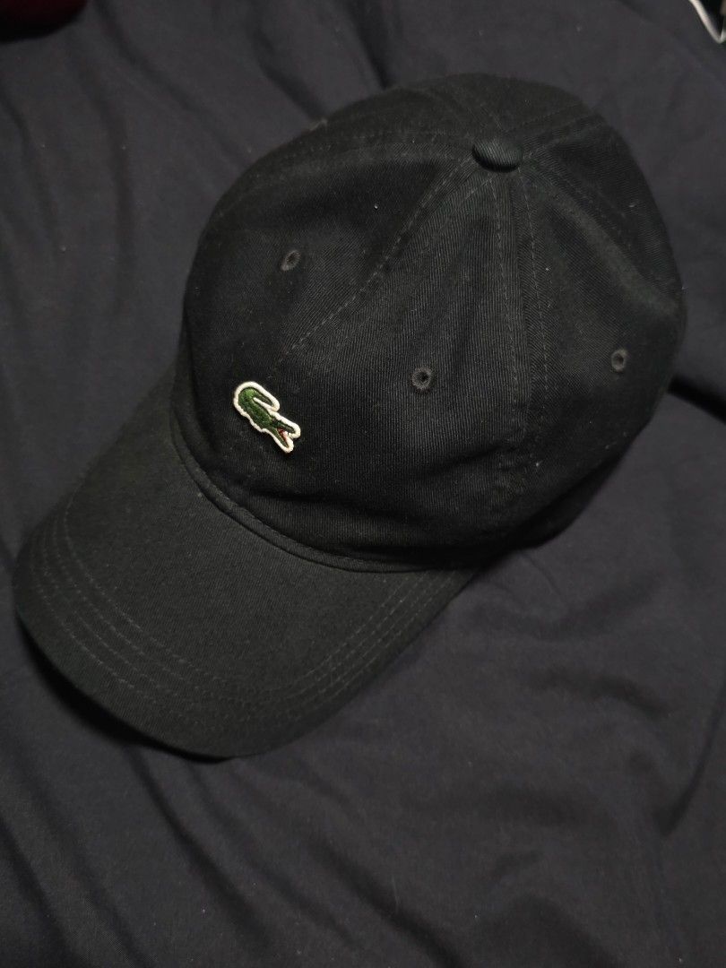 Lacoste Black Cap (Category: Caps & Hats) located in Quezon City. Submitted by yGGGG (Listing ID 1419245877, Image 1). Description: - Black Lacoste cap - Iconic crocodile logo - Curved brim - Adjustable strap - Green Lacoste branded taping inside - Made in Vietnam - Durable fabric.