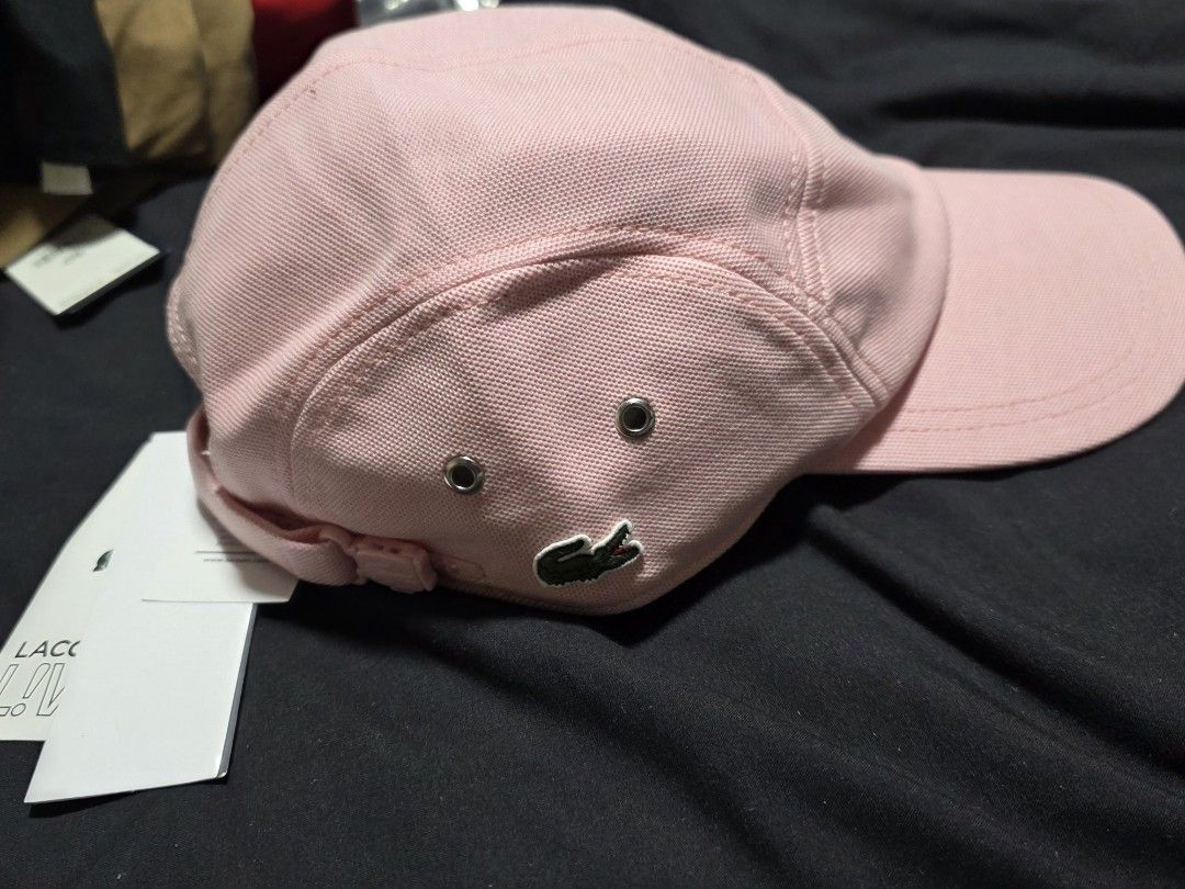 Lacoste Pink Cap (Category: Caps & Hats) located in Quezon City. Submitted by yGGGG (Listing ID 1419247132, Image 1). Description: - Brandnew - Lacoste cap - Soft pink color - Iconic Lacoste logo - Classic design with curved brim - Adjustable strap for a comfortable fit - Unworn condition - Includes original tags.